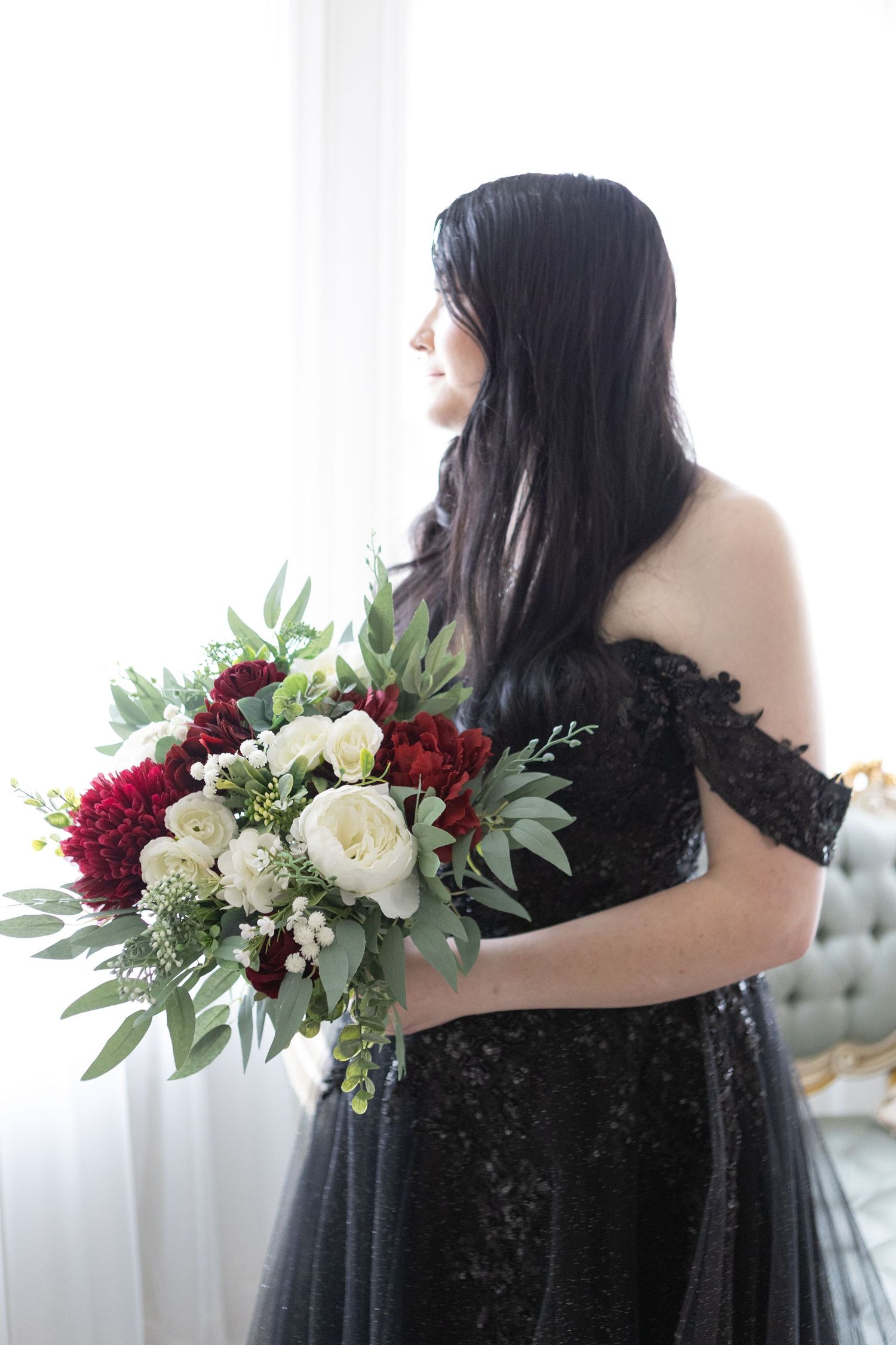 Artistic portrait series with black dress and red-white floral bouquet.
