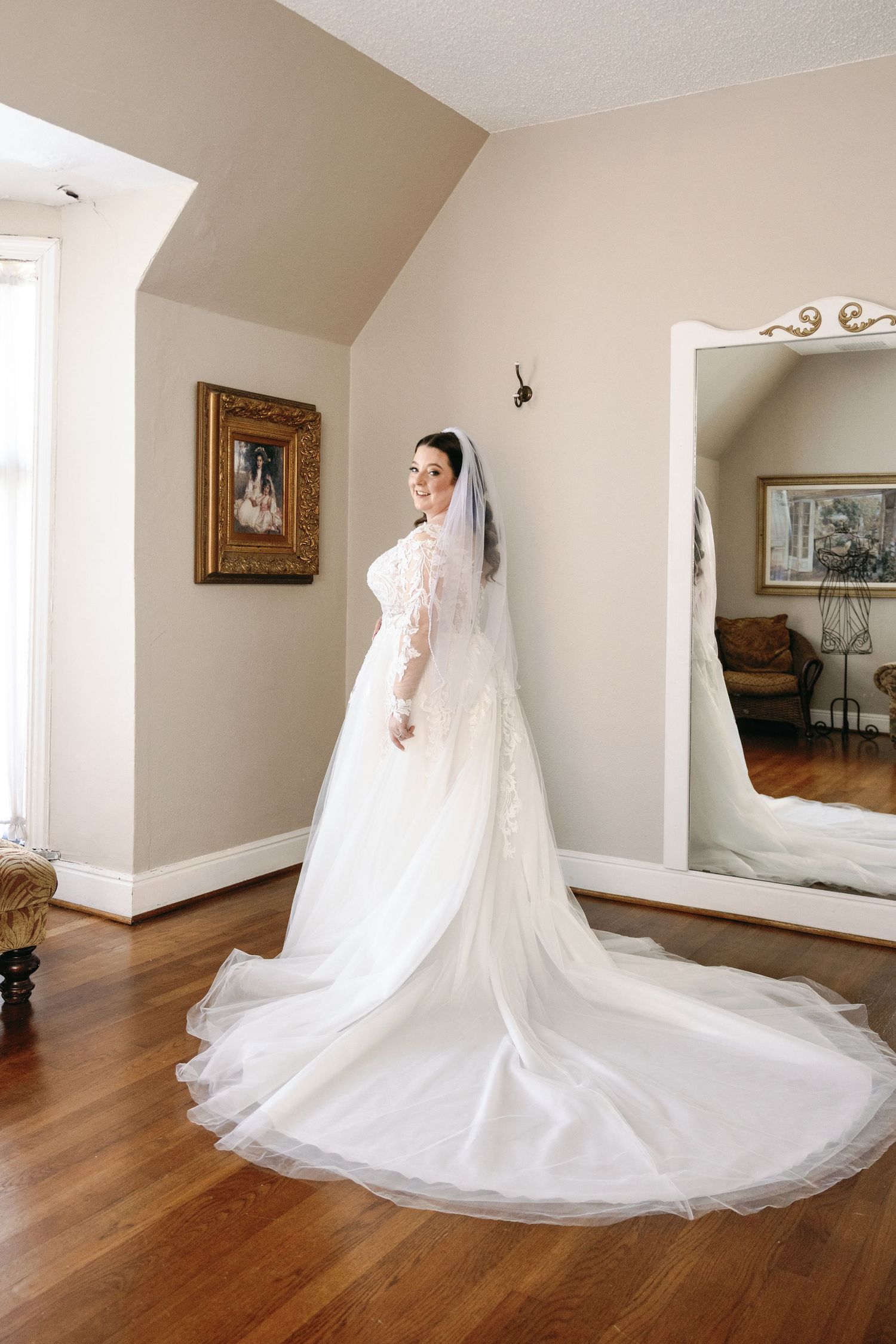 A stunning bridal portrait sequence showing a flowing white wedding gown and cathedral veil against hardwood floors.