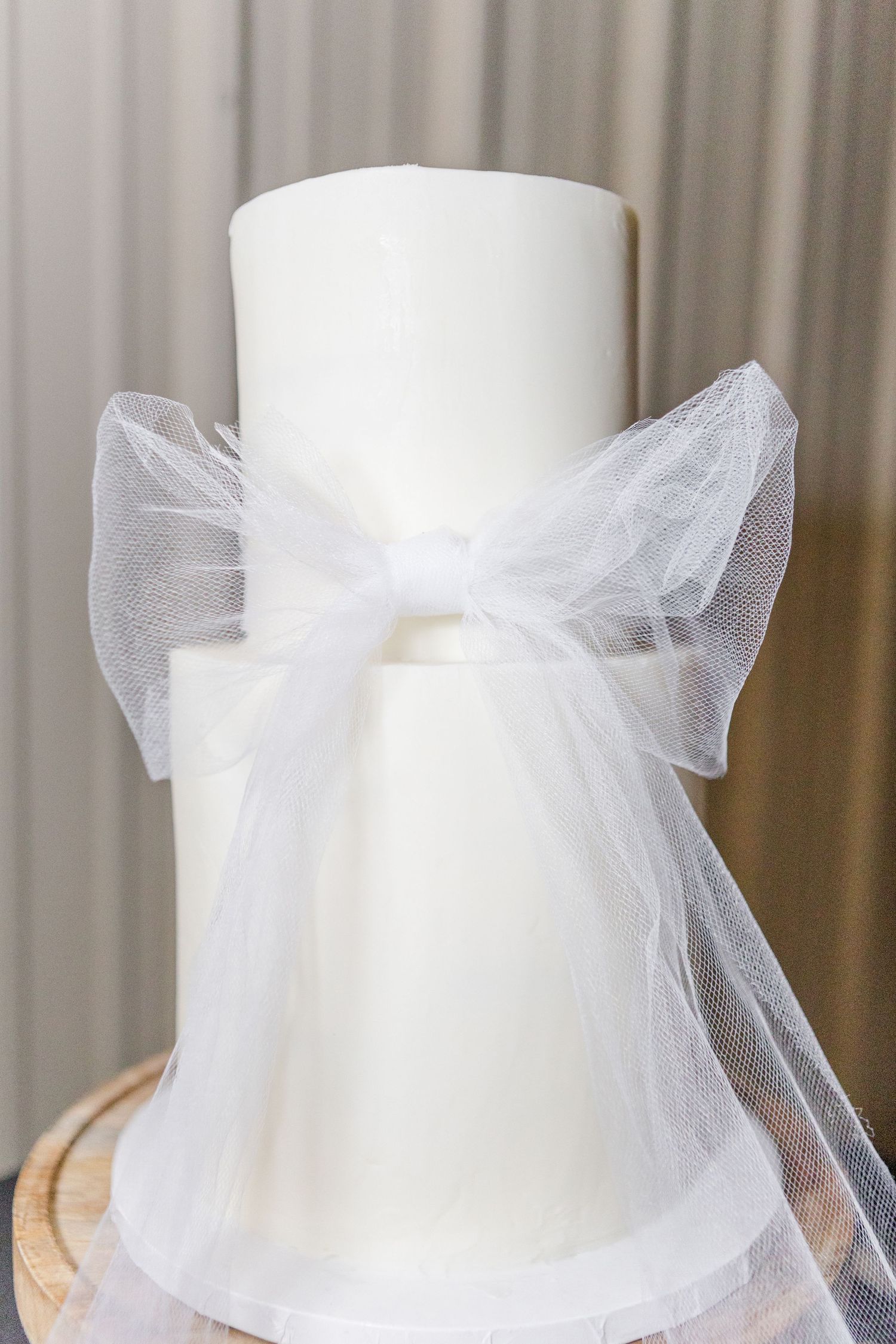 White wedding dress details with delicate tulle bows on display.