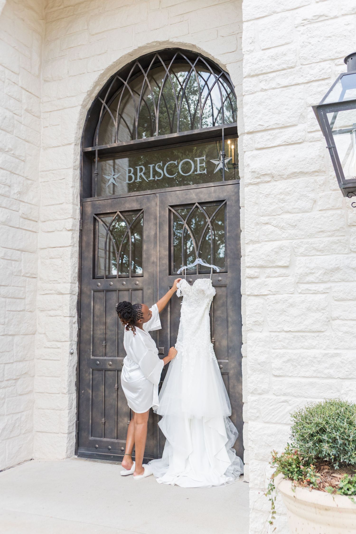 A series of four photos showing a white wedding dress and the entrance to the Briscoe building with an ornate door.