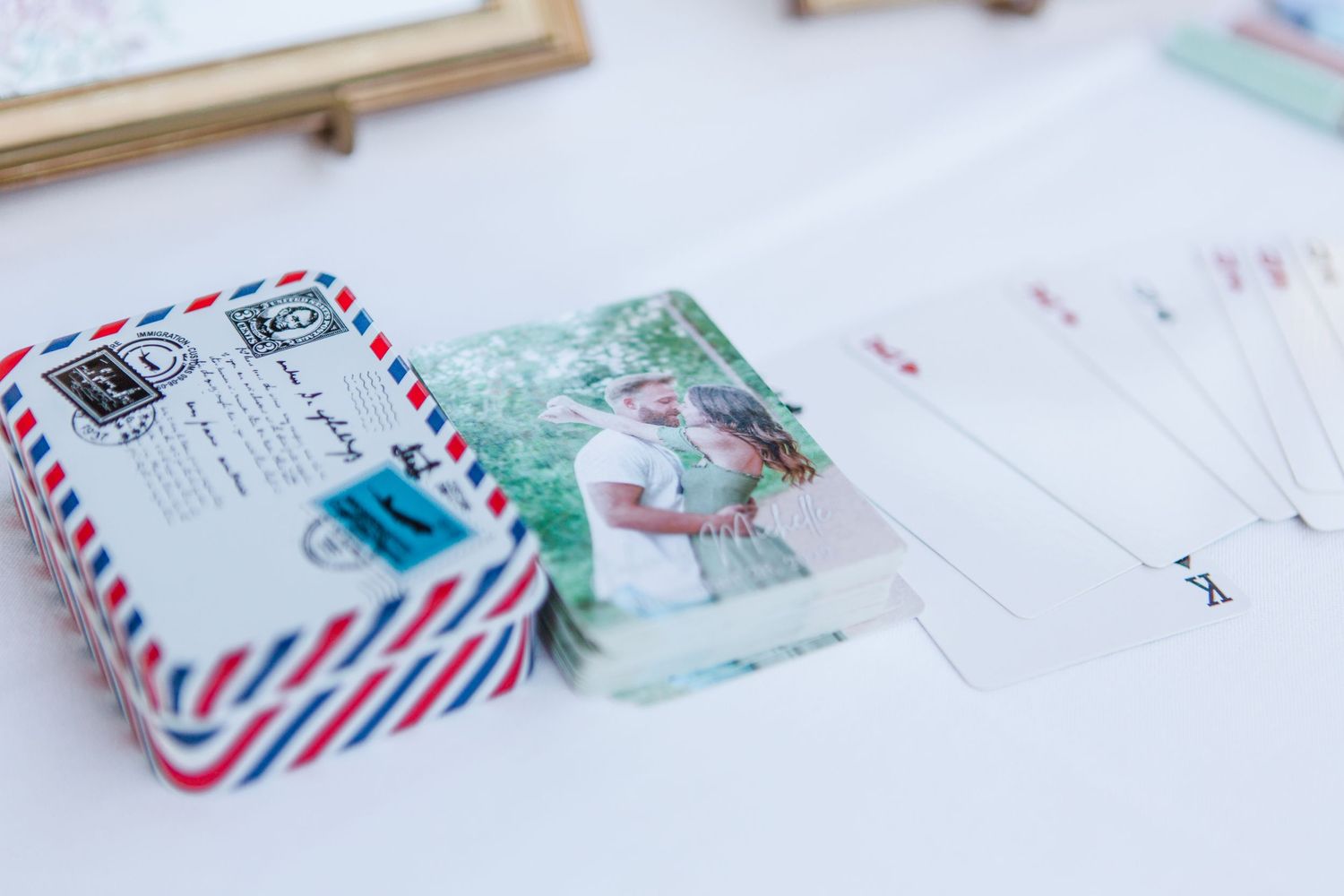 Vintage airmail envelopes and wedding stationery with decorative postmarks laid out on white surface.