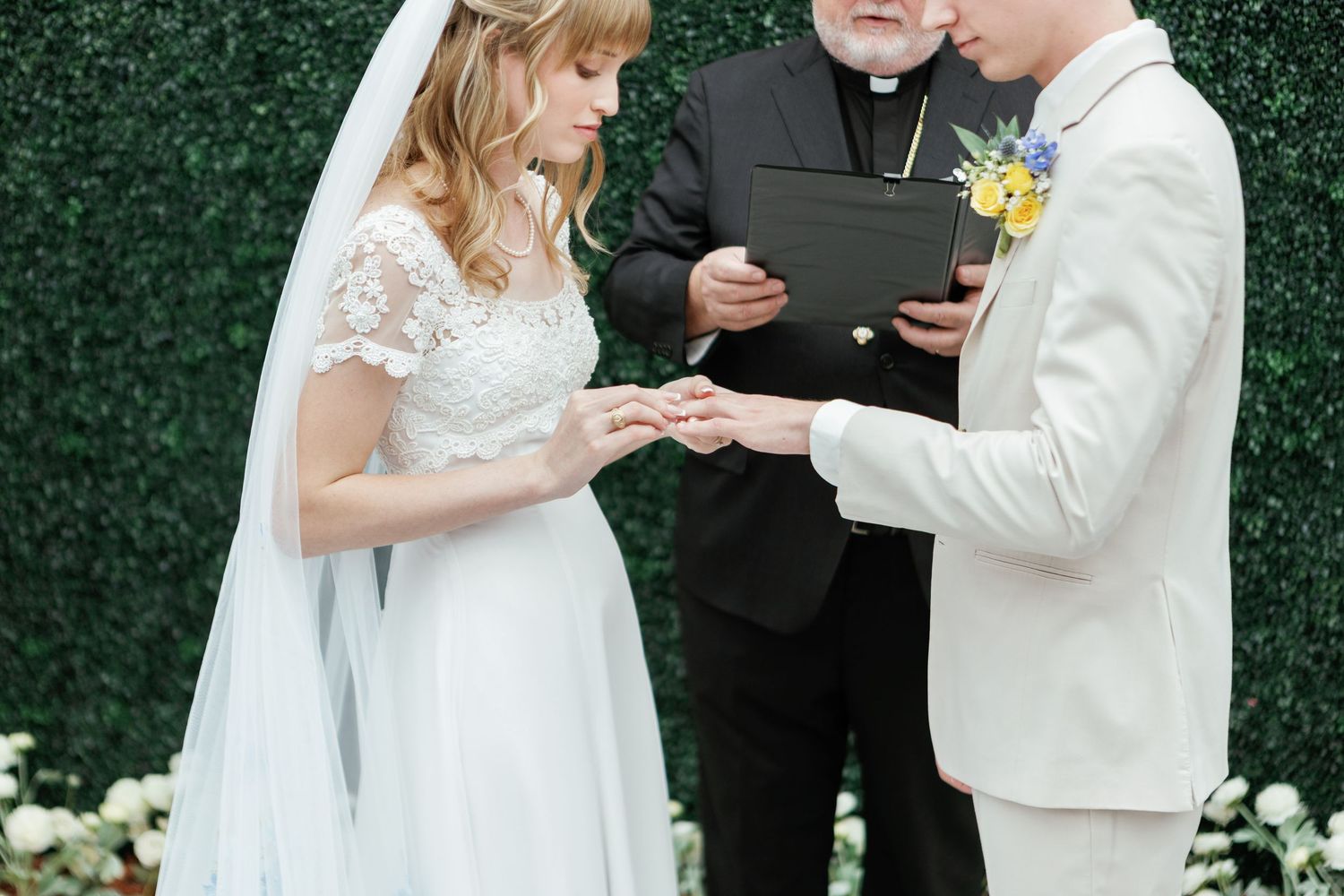 Intimate wedding ceremony moment with couple exchanging vows in front of officiant.