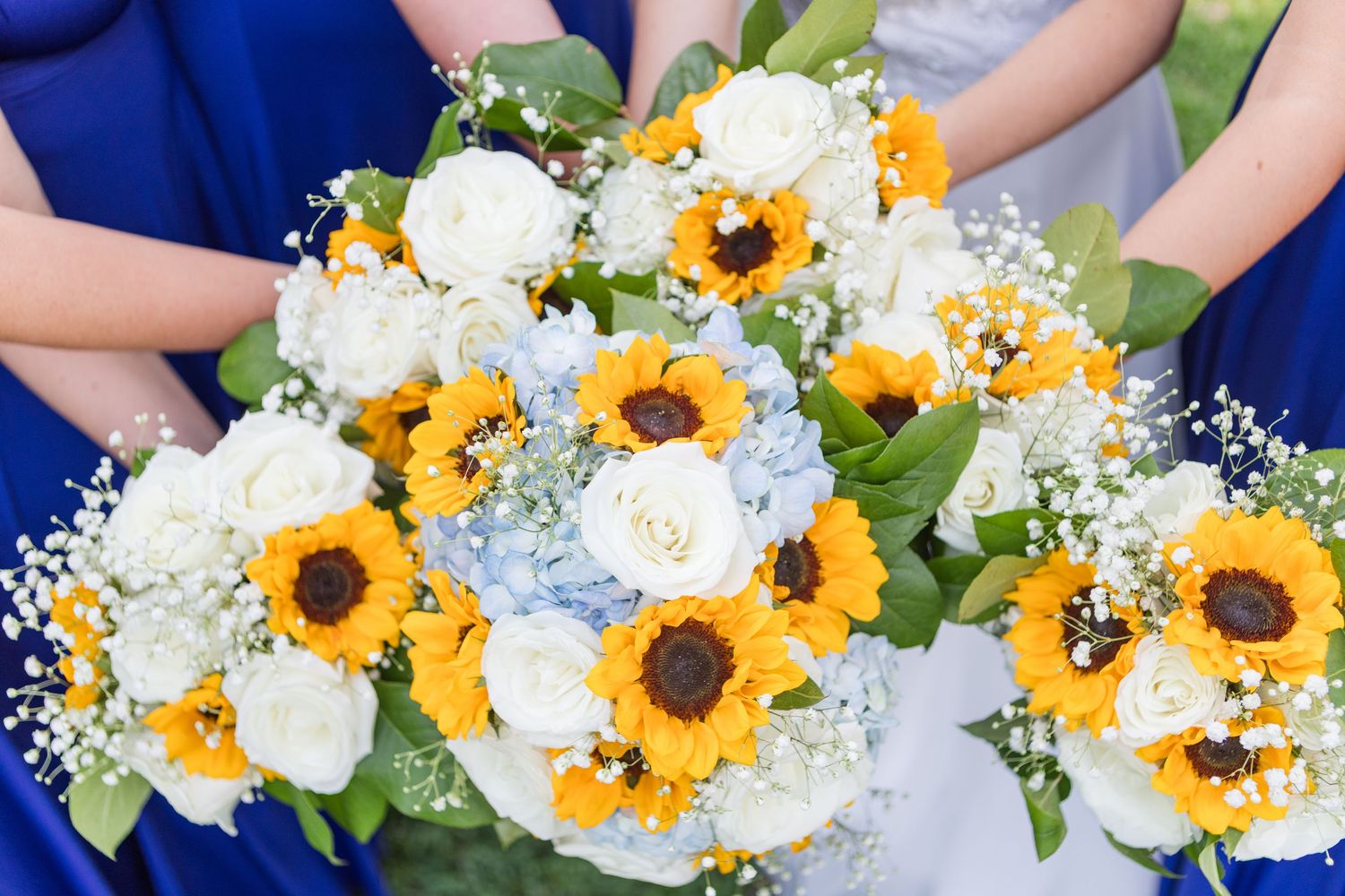 Beautiful wedding bouquets featuring bright yellow sunflowers mixed with white flowers and greenery.