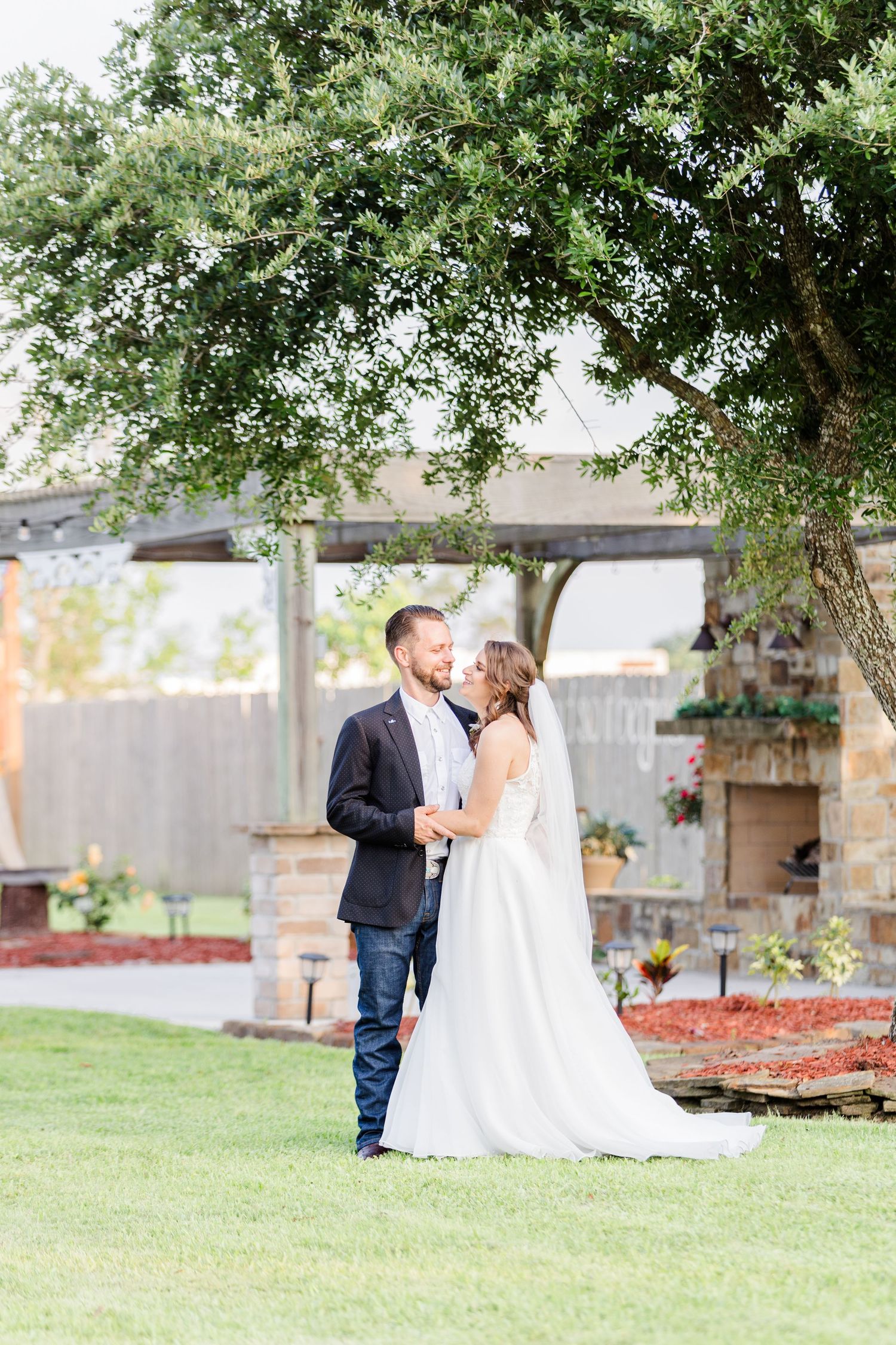 A romantic outdoor wedding photo series showing a couple sharing intimate moments under trees.