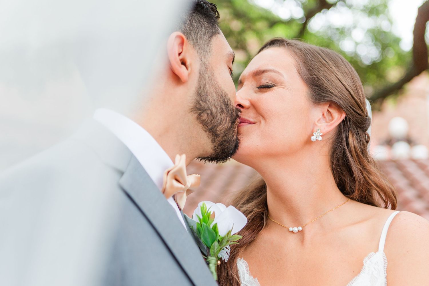 Dreamy wedding portraits showcase tender embraces with soft lighting and floral details.