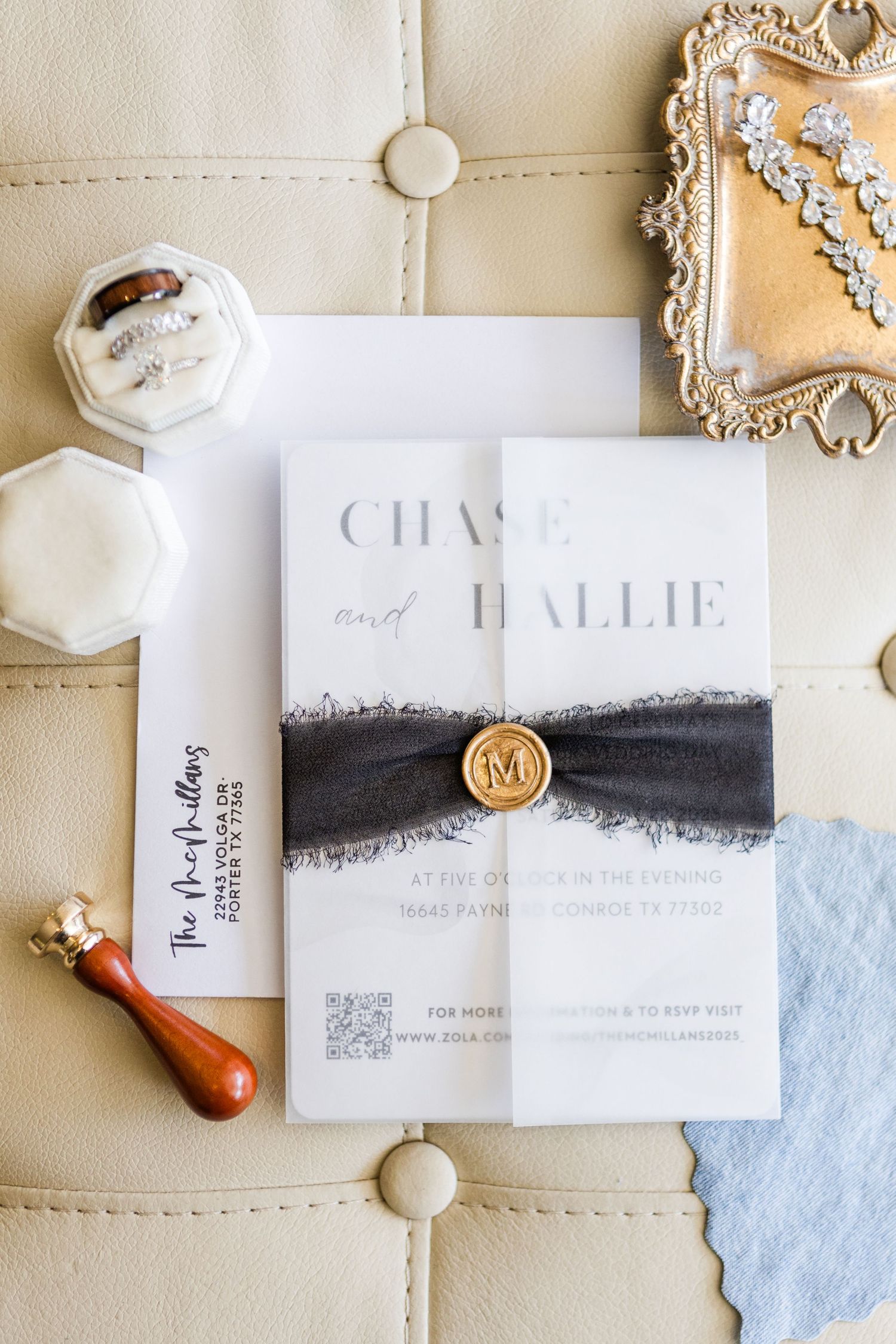 Modern minimalist wedding invitations featuring black watercolor details and wax seals on cream background.