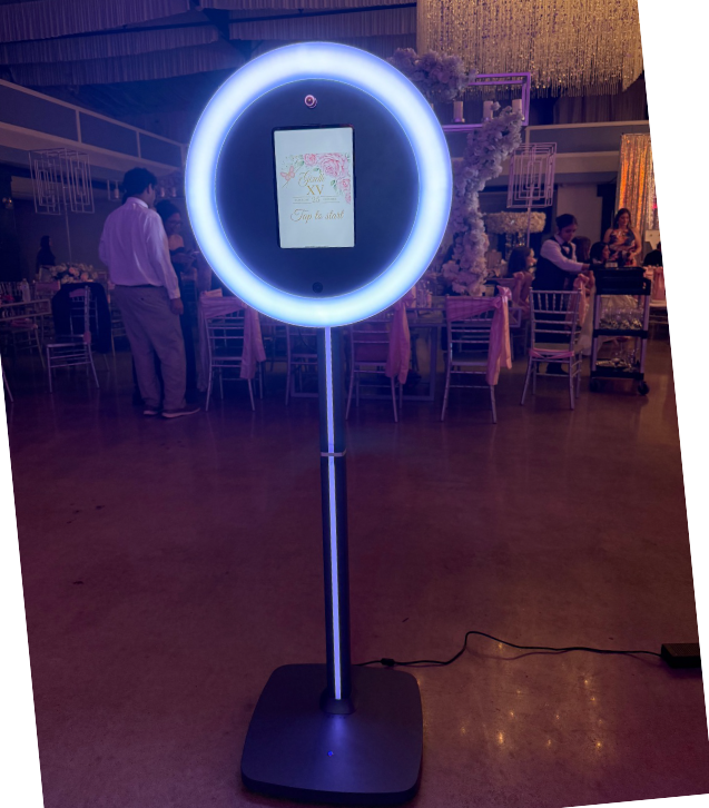 A circular blue LED ring light stands on a dark floor in what appears to be an event space or venue.