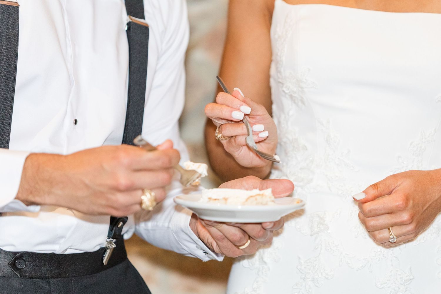Cropped view of wedding party members in white and black formal attire.