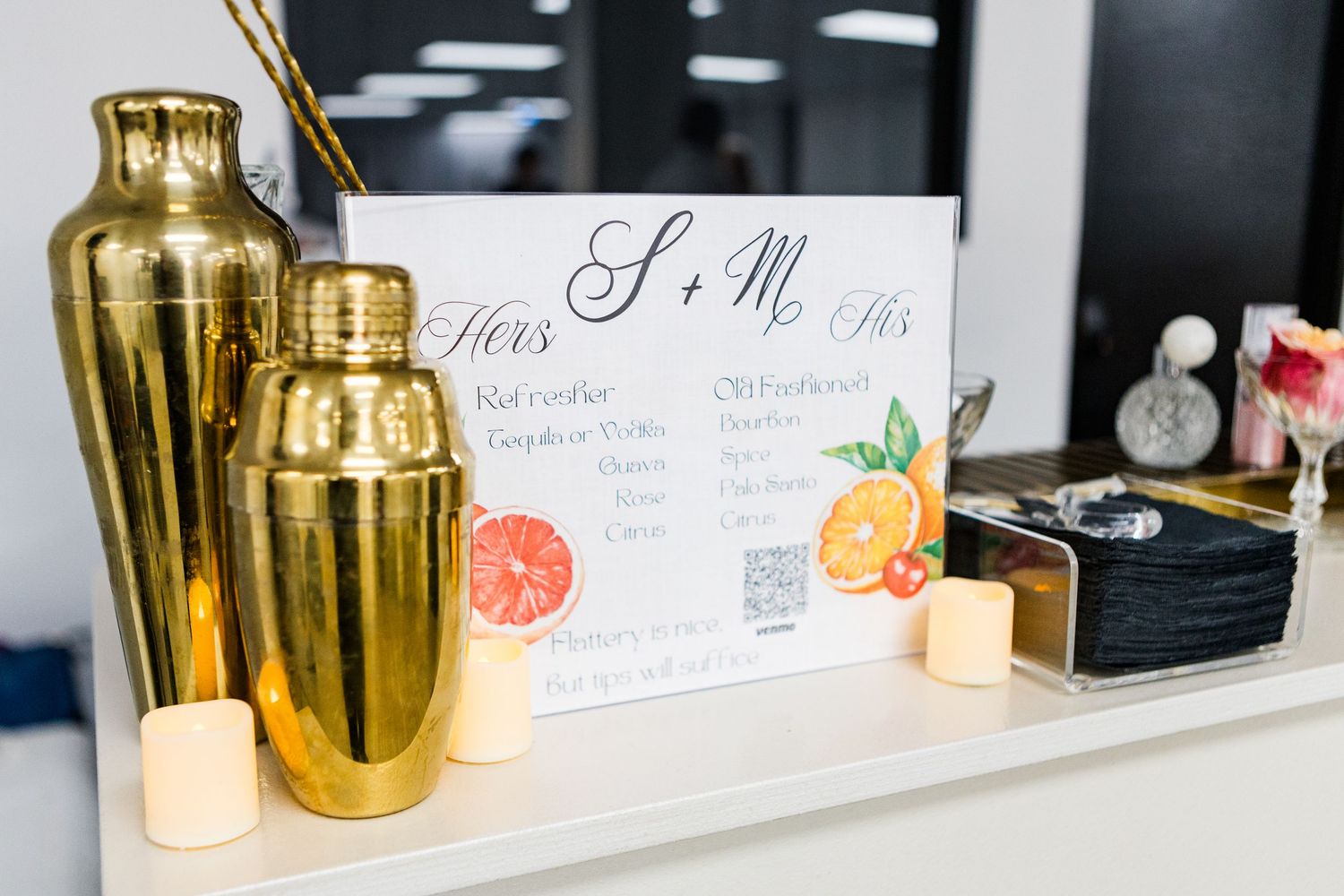 Wedding reception table setting with gold accents and citrus-themed decor.