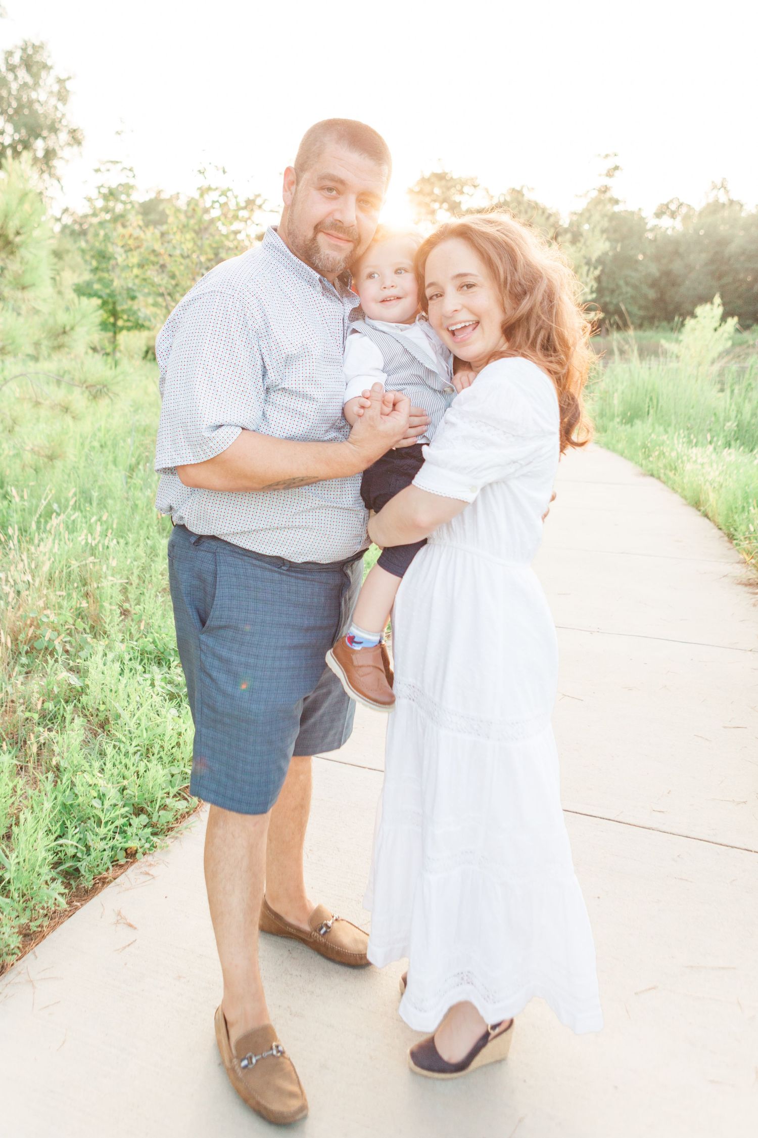 mom and dad holding child pose