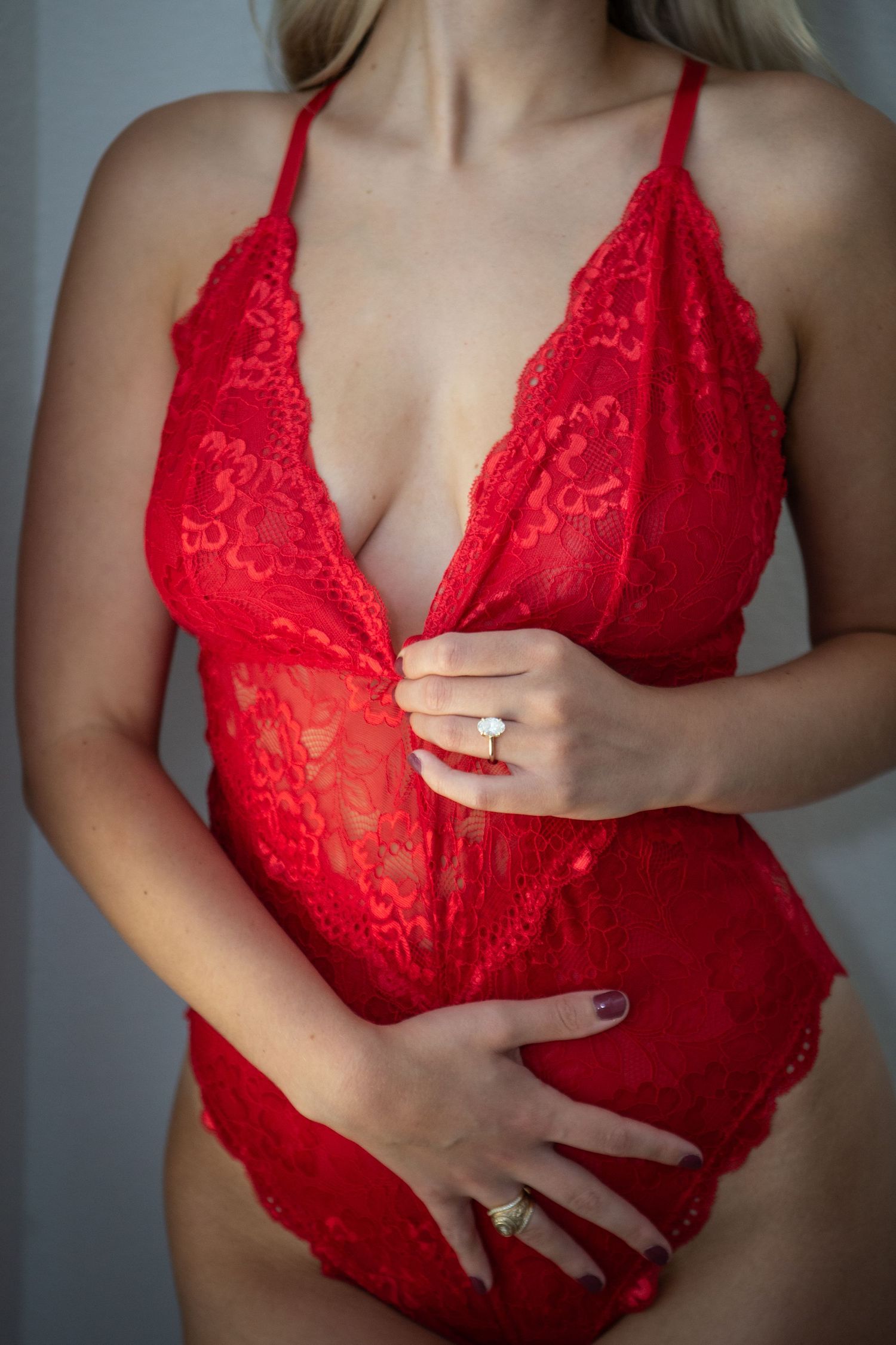Close-up shots of red lace lingerie with hands gracefully positioned.