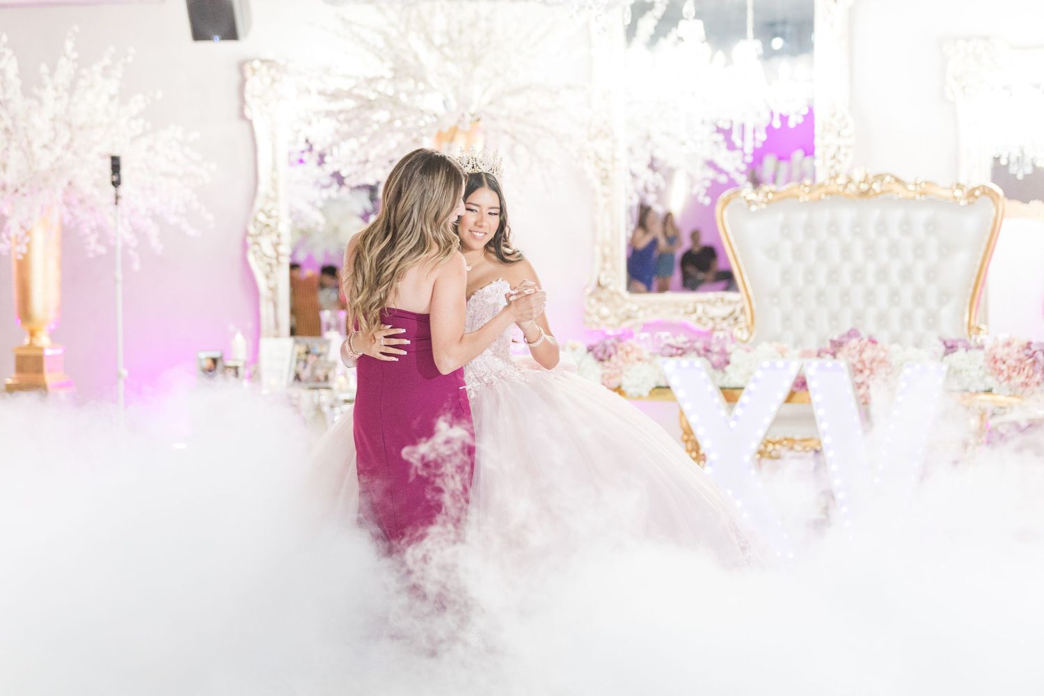 Dreamy pink and white decorated celebration space with soft lighting.
