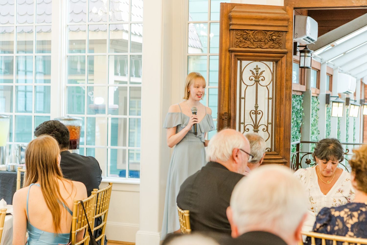 Wedding guests seated at elegant tables during reception dinner.