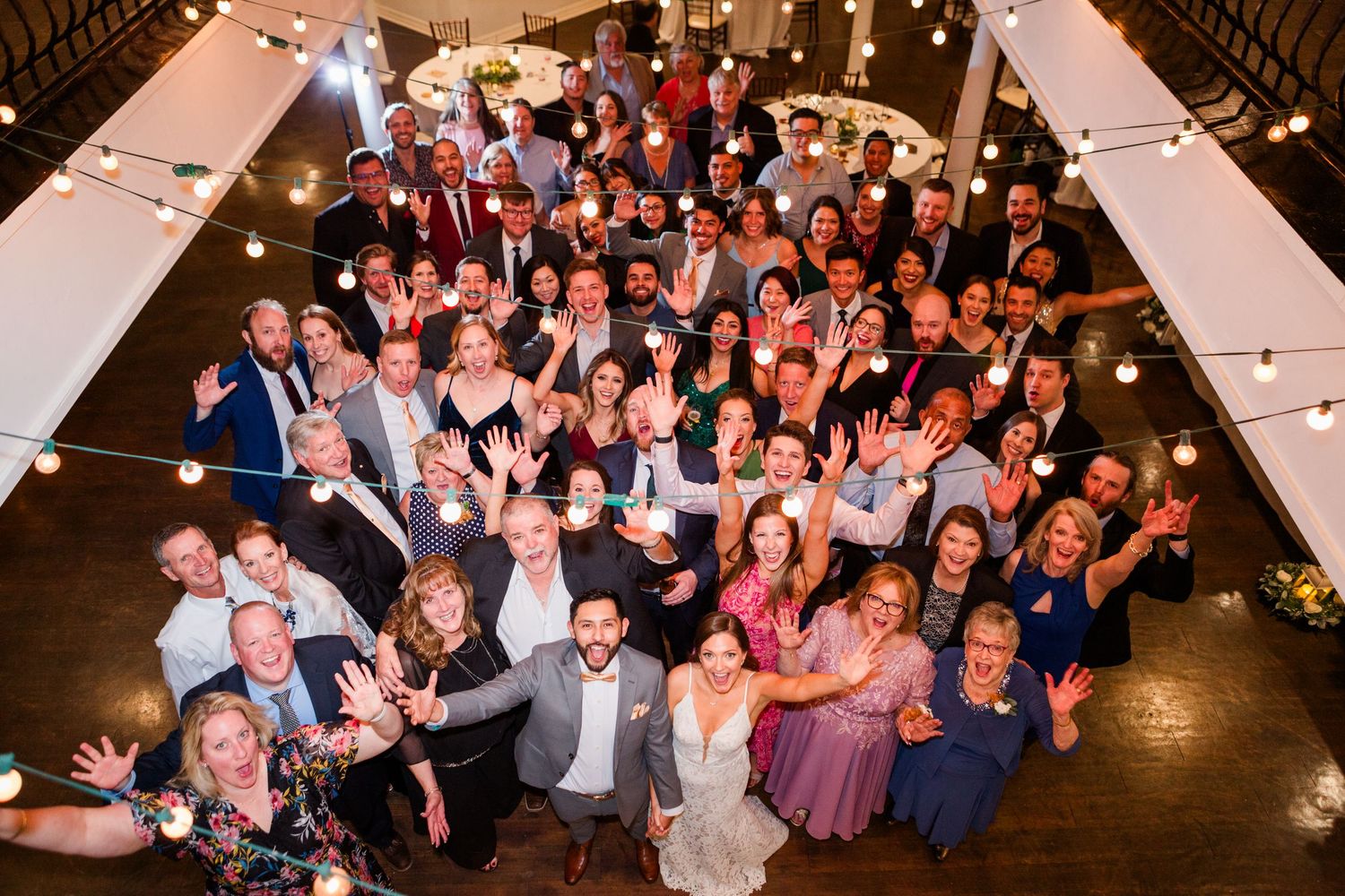 Large group of wedding guests gathered for celebration photo.