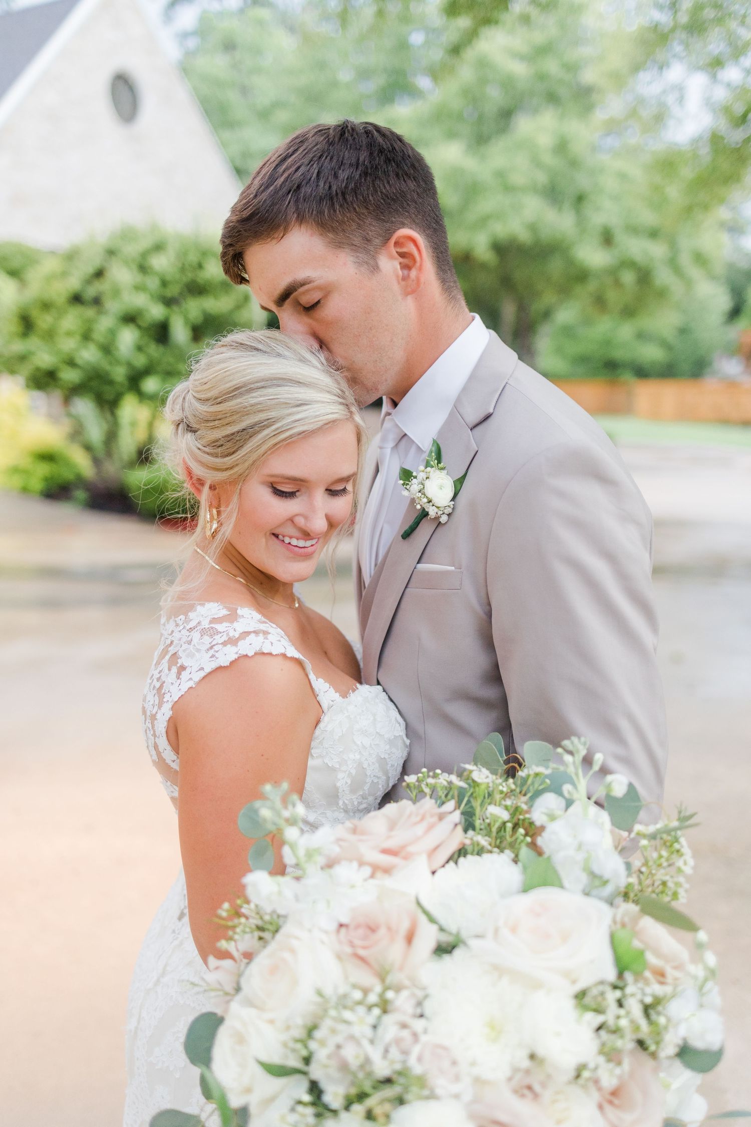 Romantic wedding portraits featuring elegant white floral bouquets and formal attire.