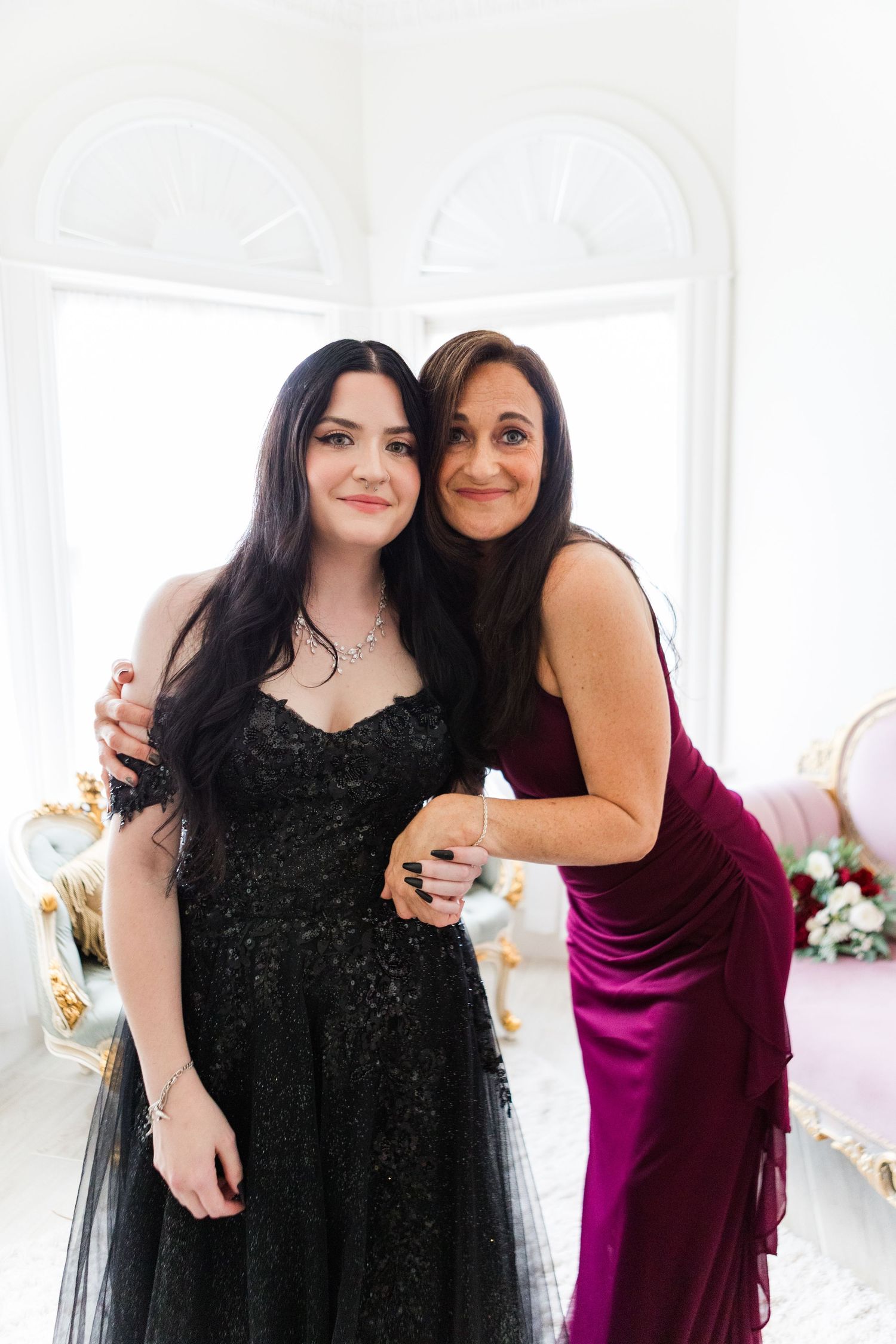 Two people embracing in formal attire during a special occasion photoshoot.