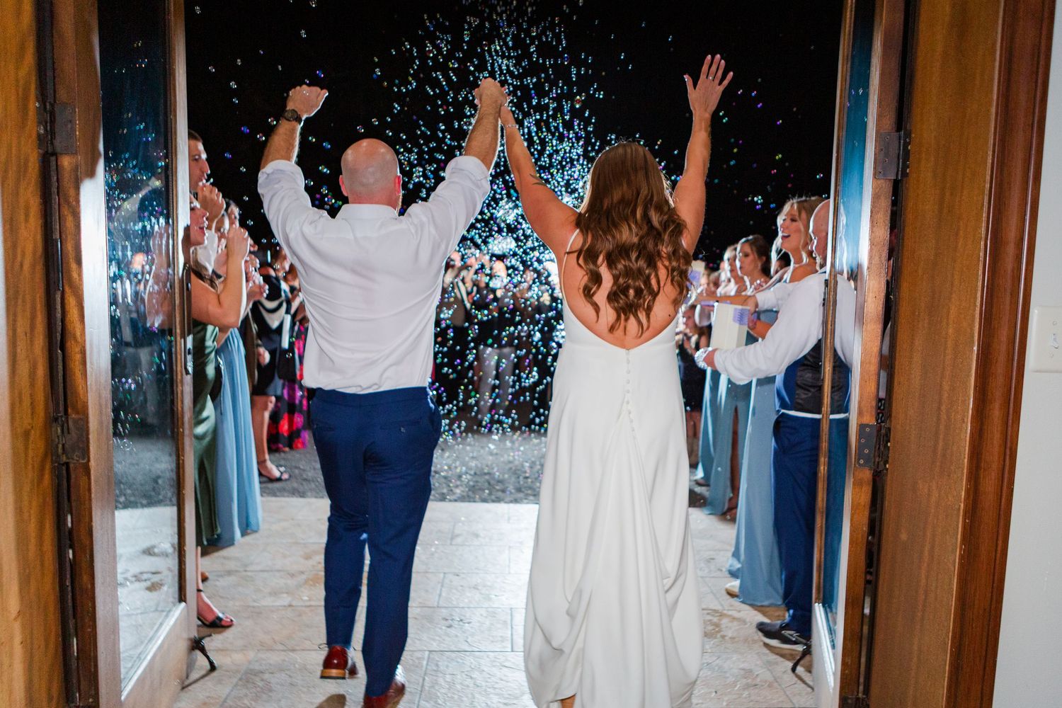 Confetti raining down on wedding guests during a celebration moment.
