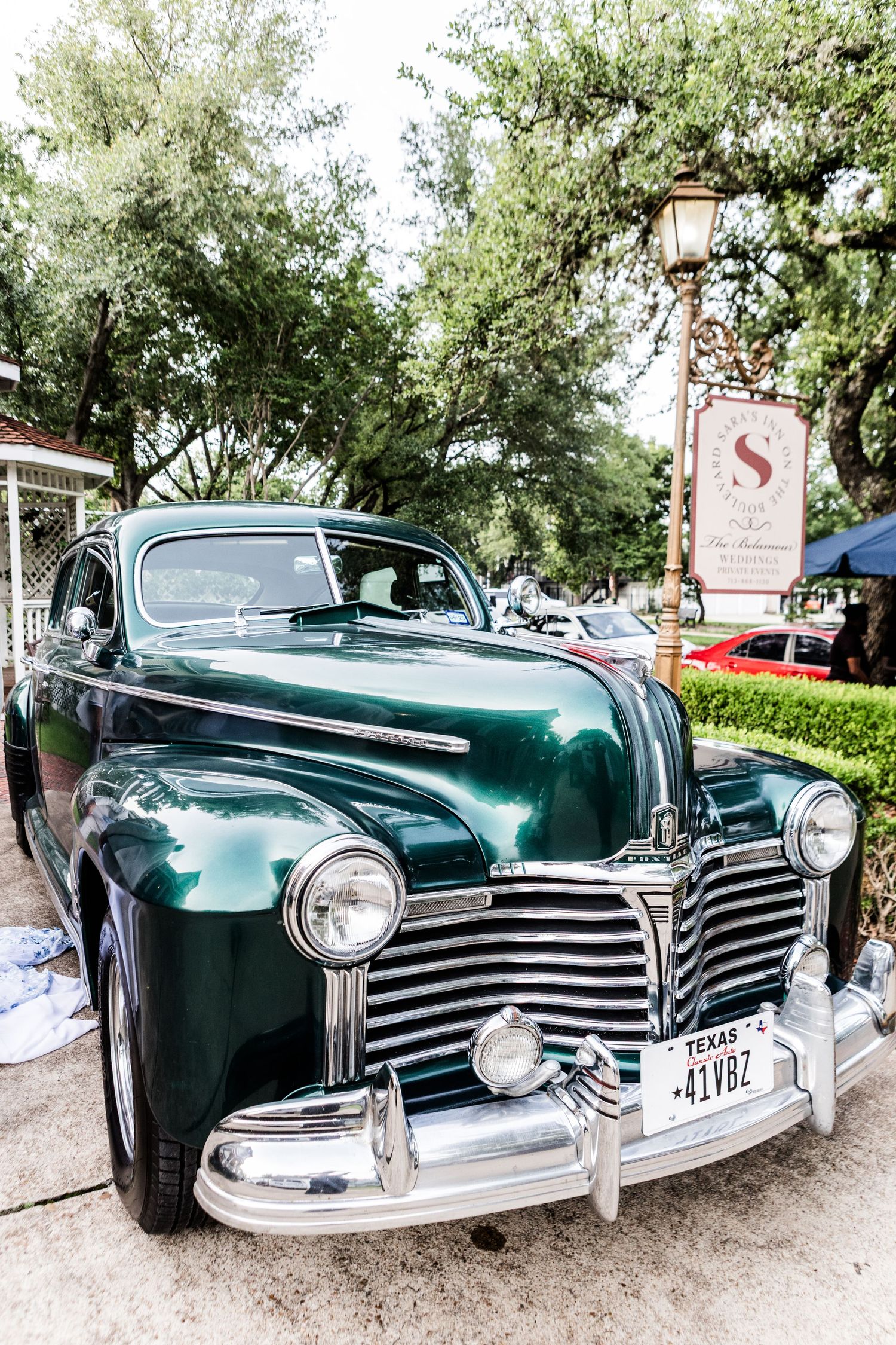 Vintage Pontiac car in emerald green shown from different angles with iconic chrome grille.