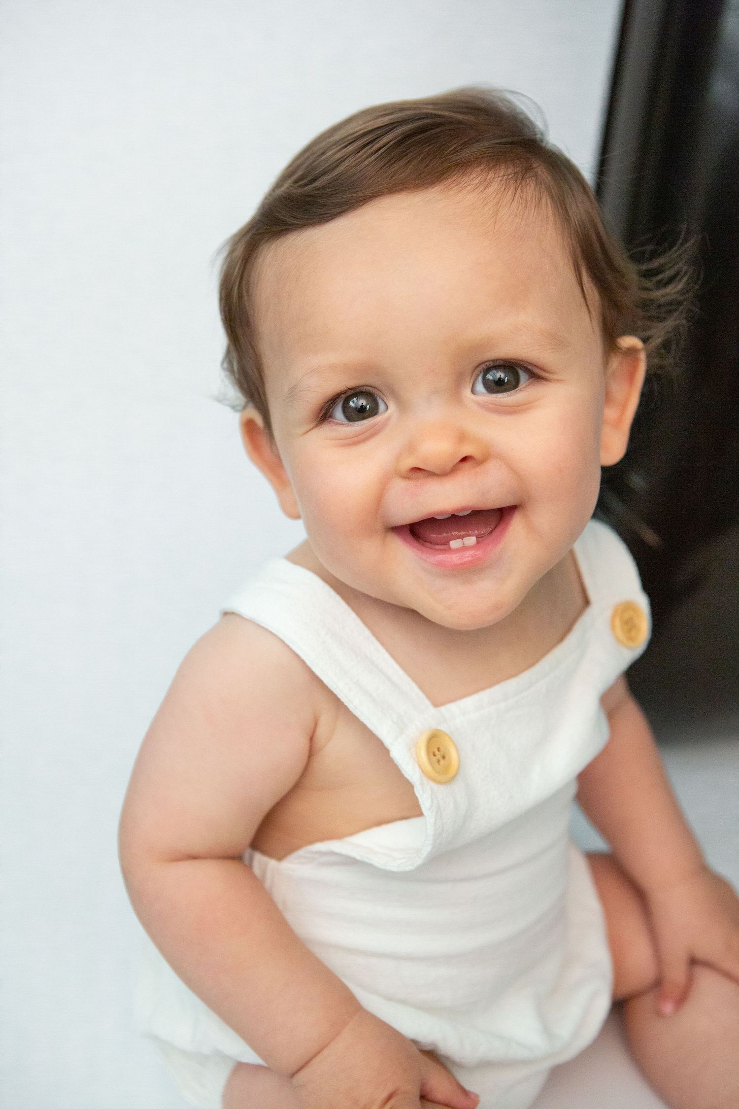 Sweet portrait in a white outfit with wooden button detail.