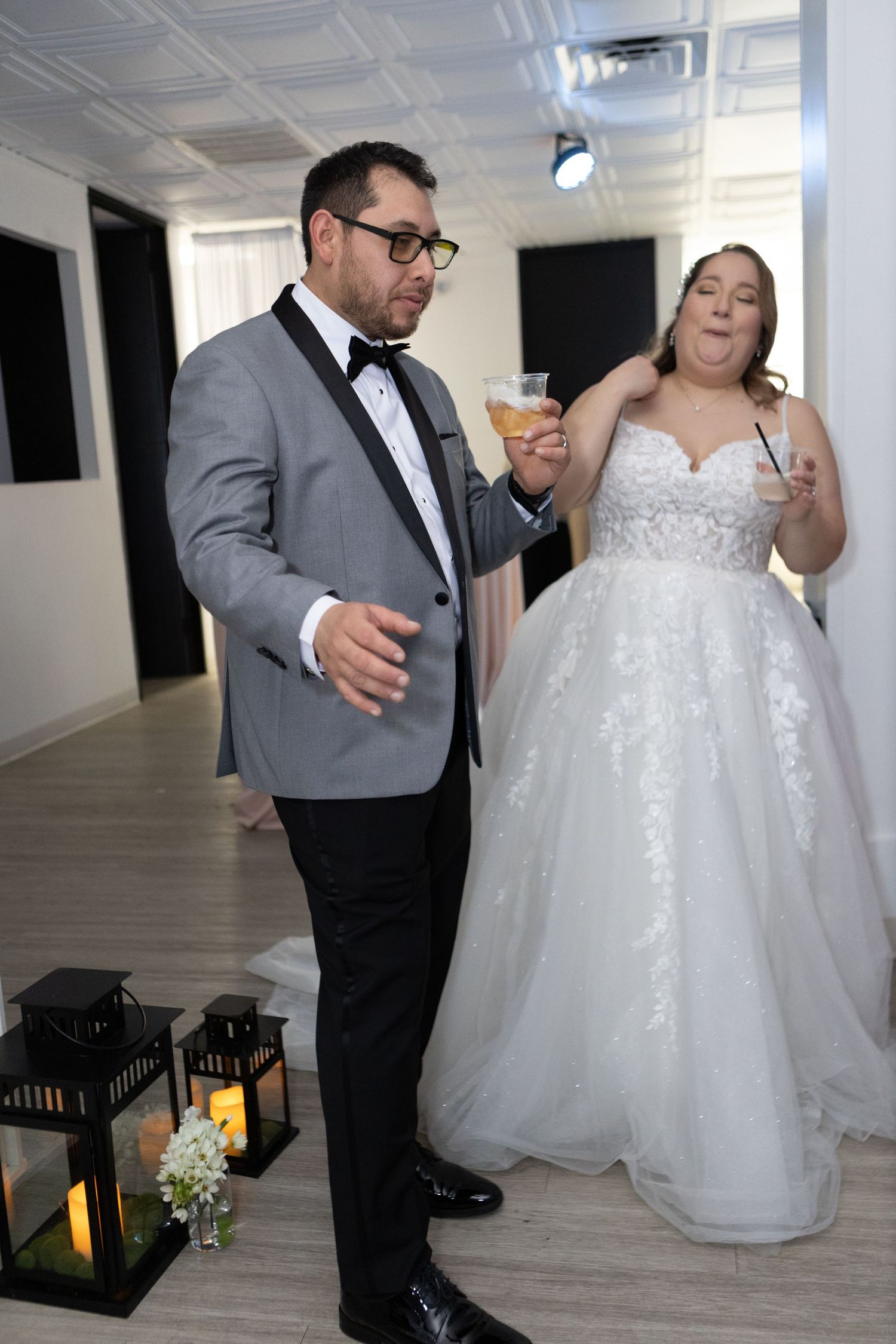 Celebratory moment at formal event with elegant attire and decorative lanterns.