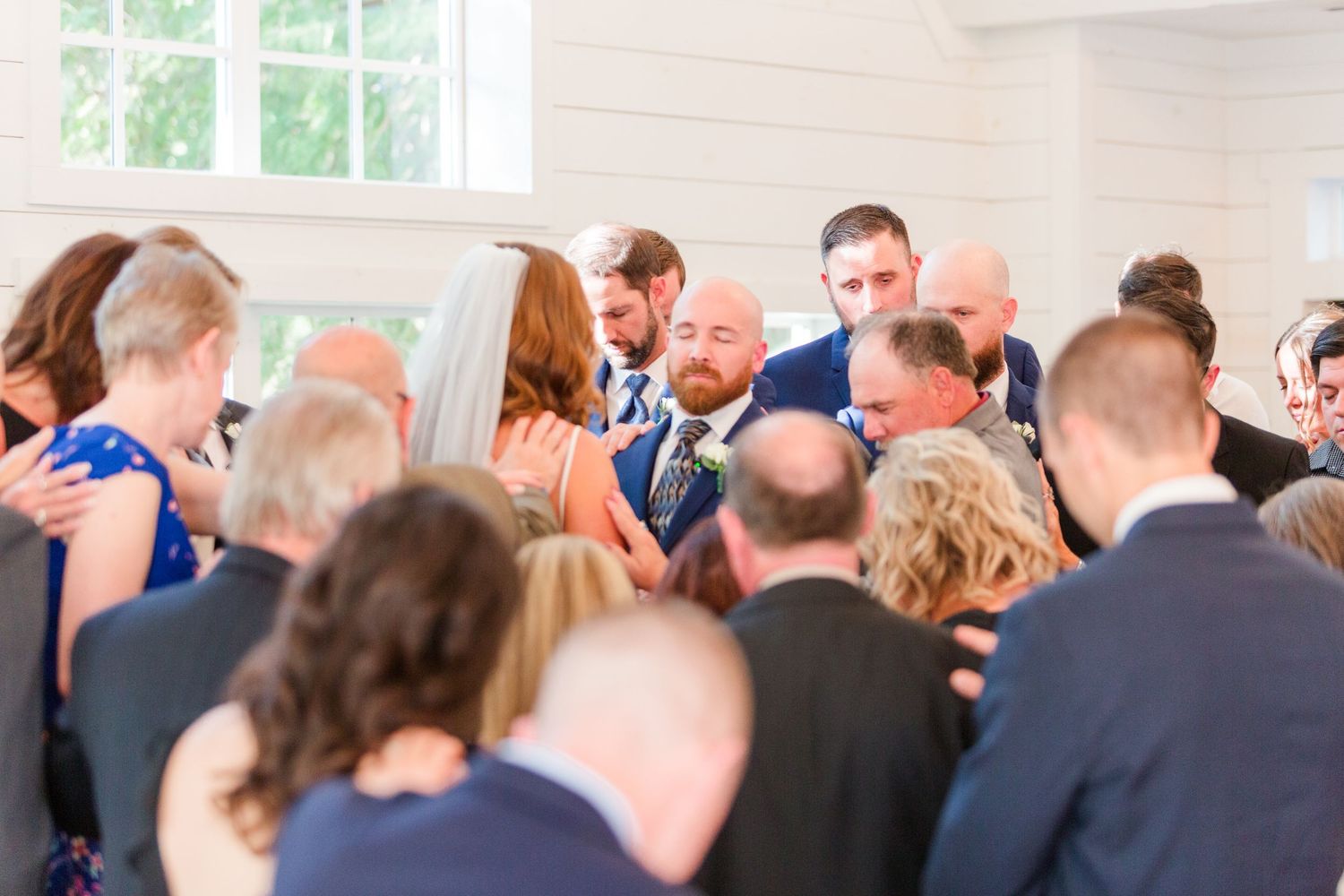 Wedding attendees standing together during an intimate indoor celebration.