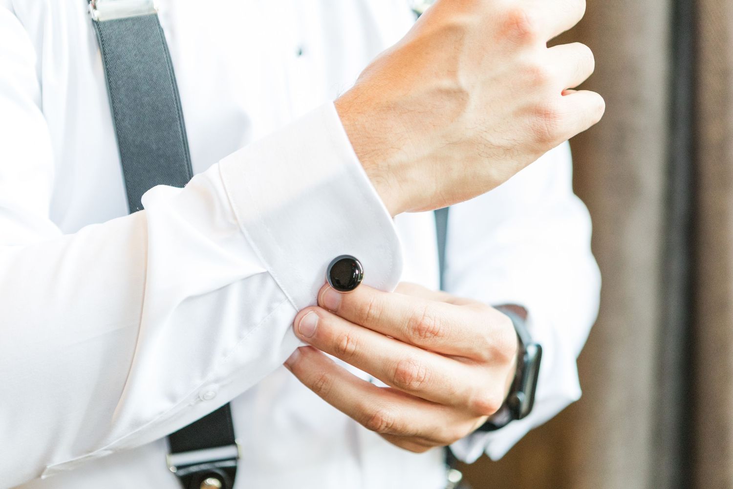 Close-up shots of hands adjusting formal attire and accessories.