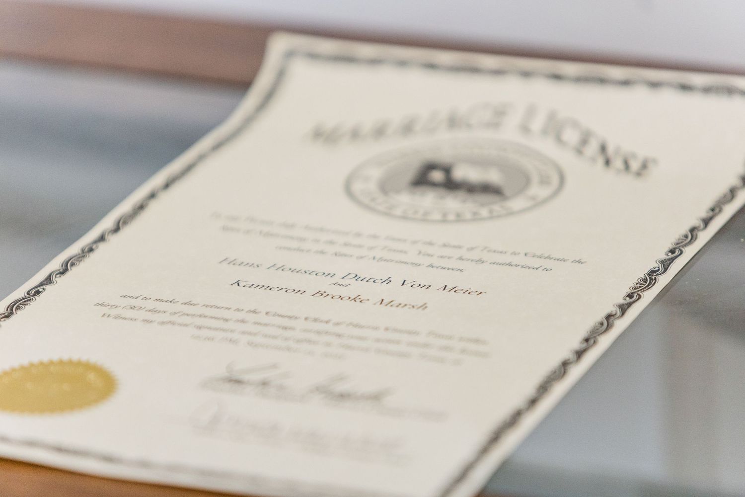 Row of elegant wedding certificates and documents laid out on a white surface.