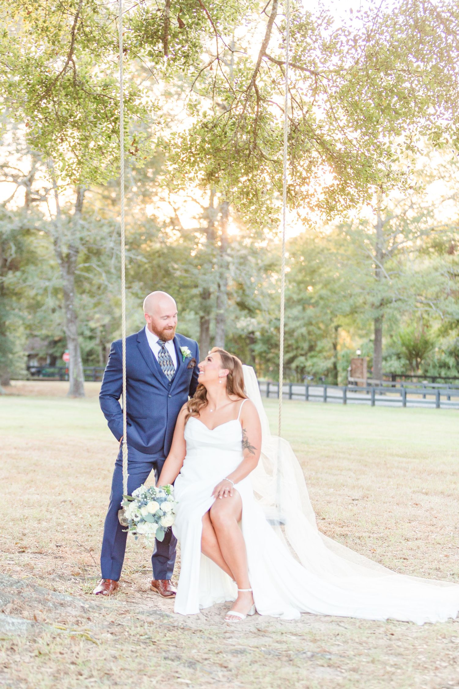 Romantic outdoor wedding photos taken in a sun-drenched park setting.