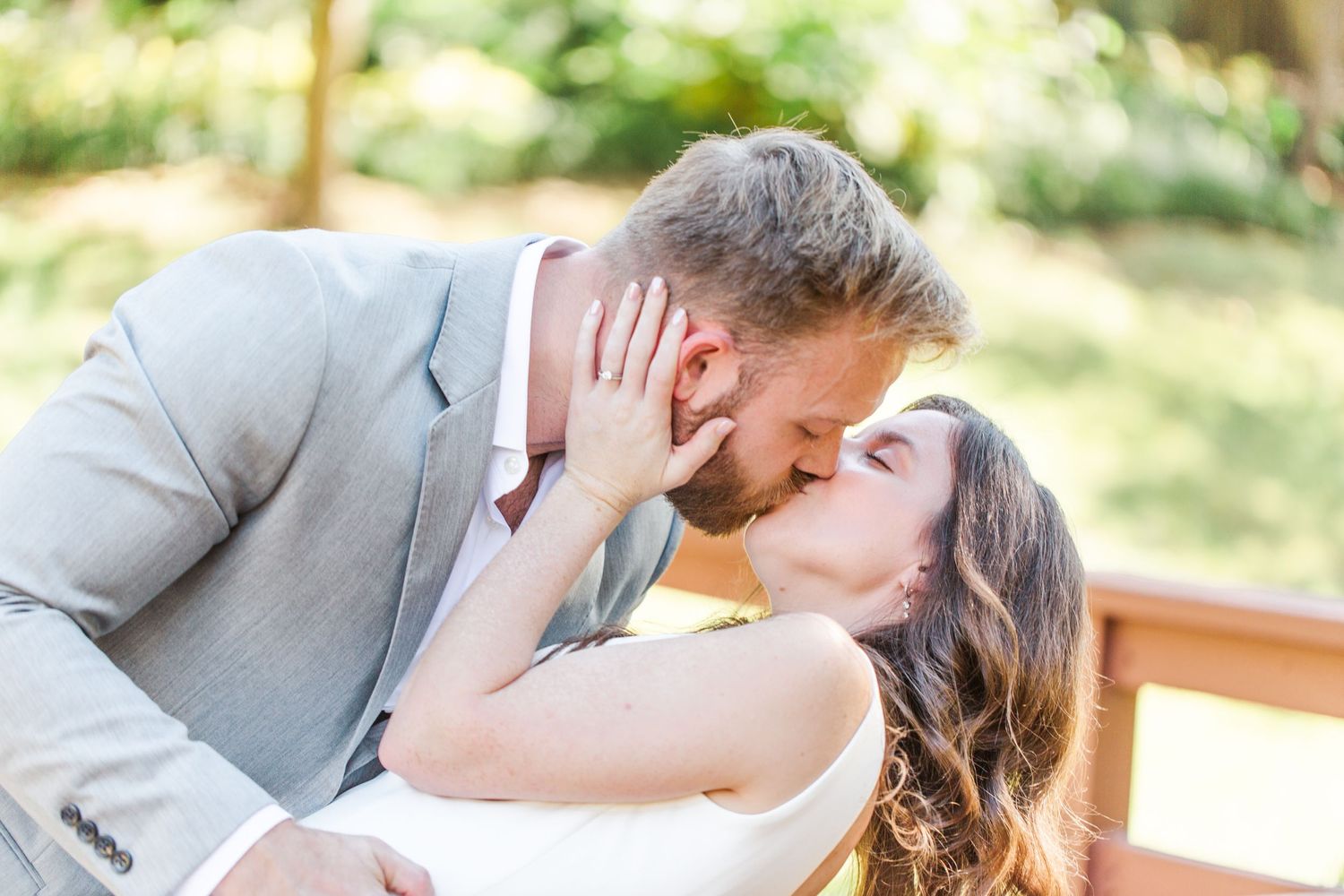 Romantic outdoor wedding portraits captured in natural sunlight through trees.