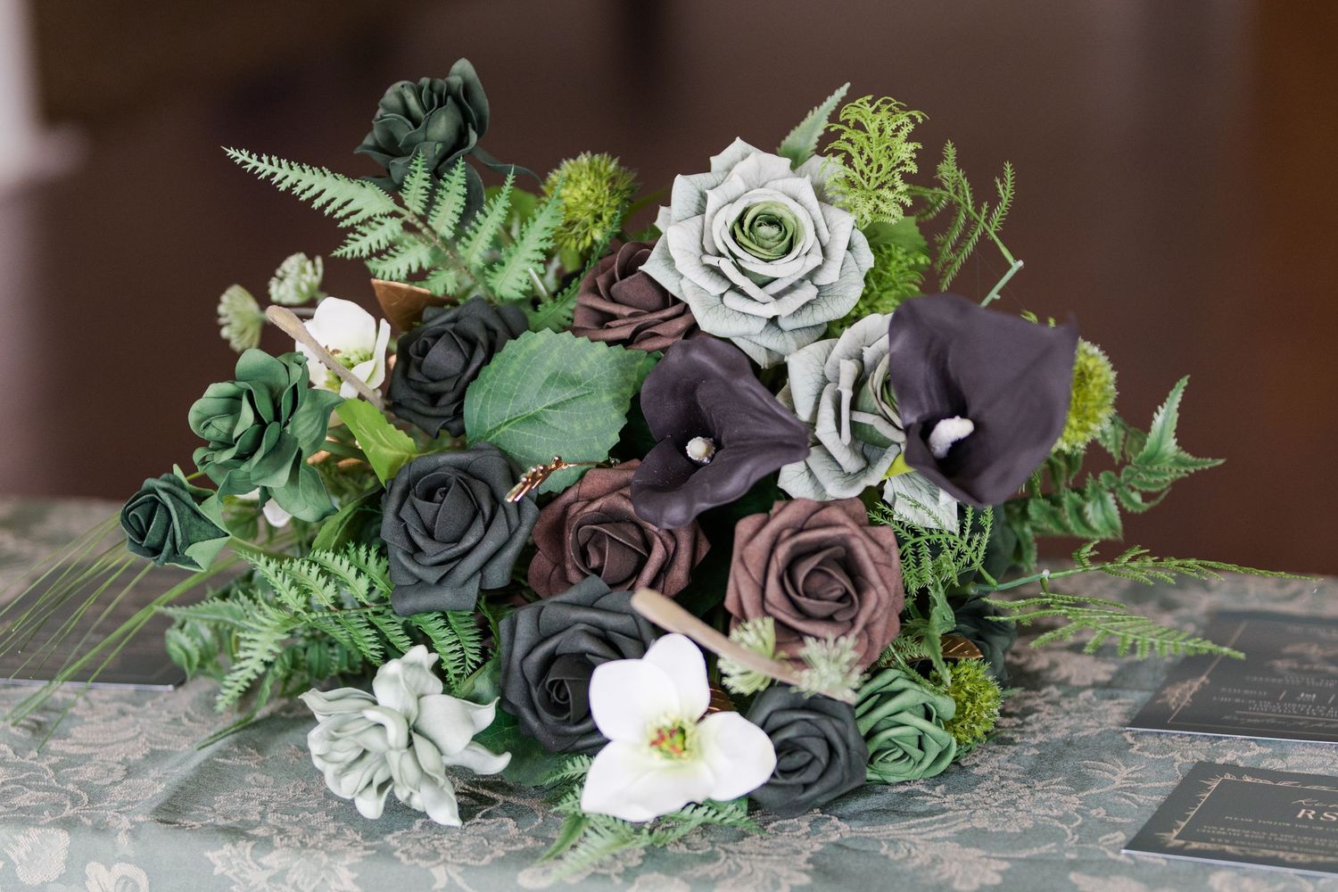 Succulent and floral wedding crown with white blooms and greenery arranged in a circular design.