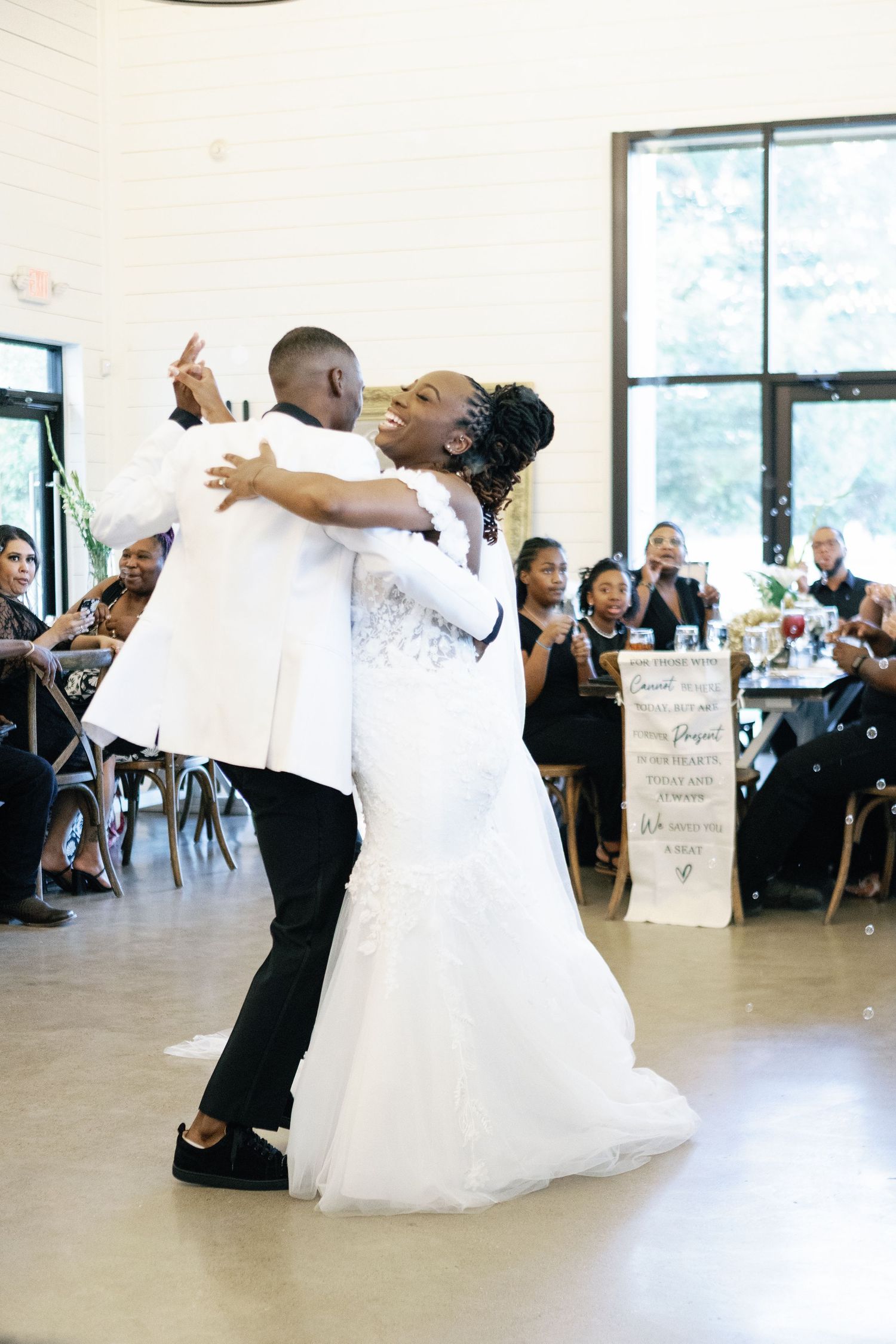 A sequence of wedding dance photos showing a couple performing lifts and spins in a bright reception venue.