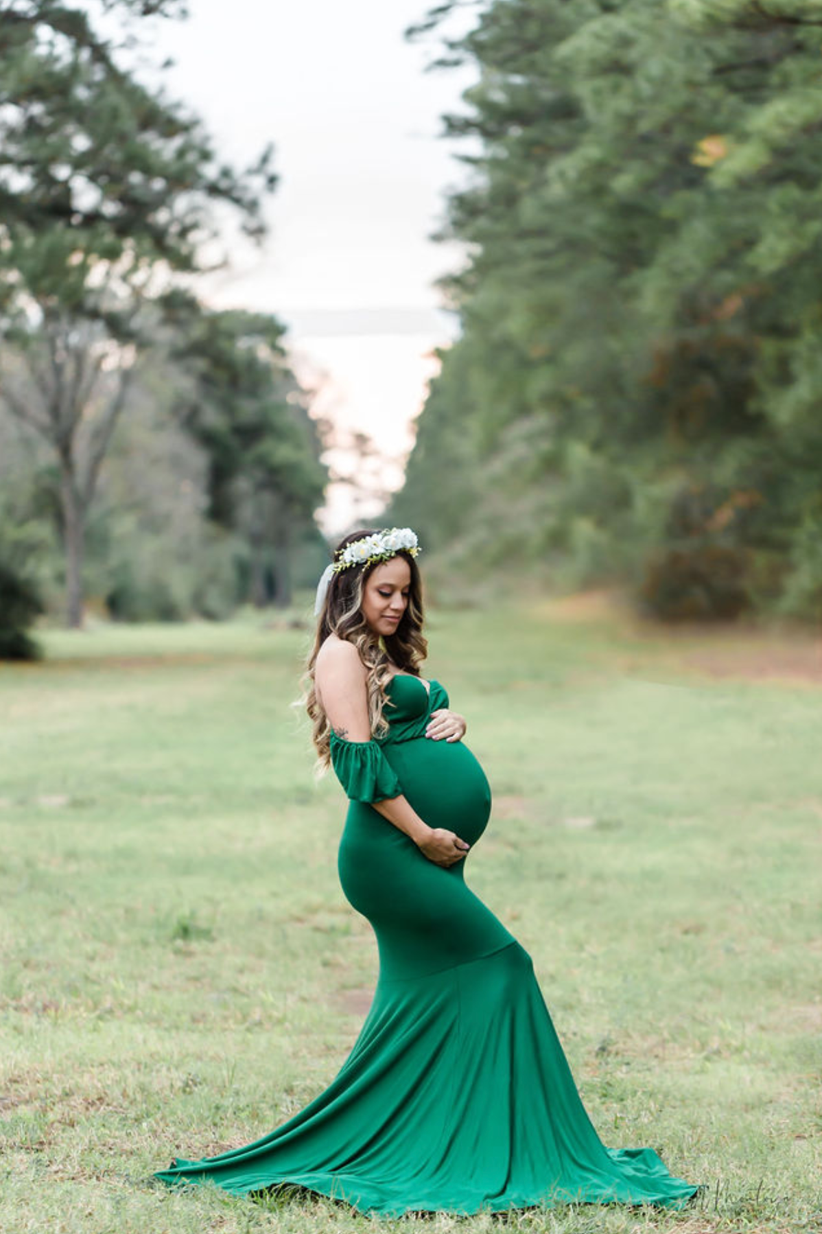 Flowing emerald green dress photographed in sequence across grassy field.