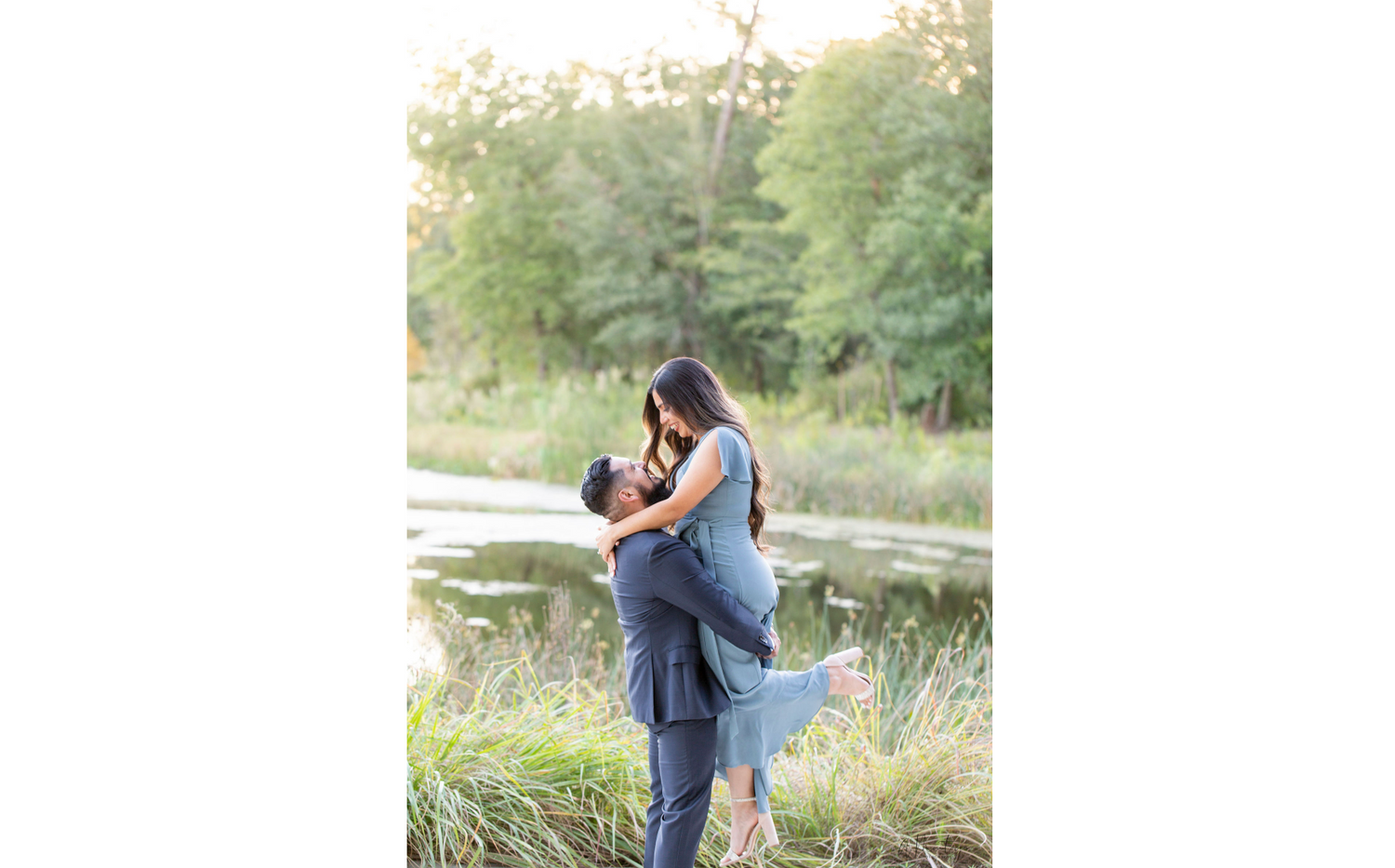 Couple embraces during romantic outdoor photo session in natural setting.