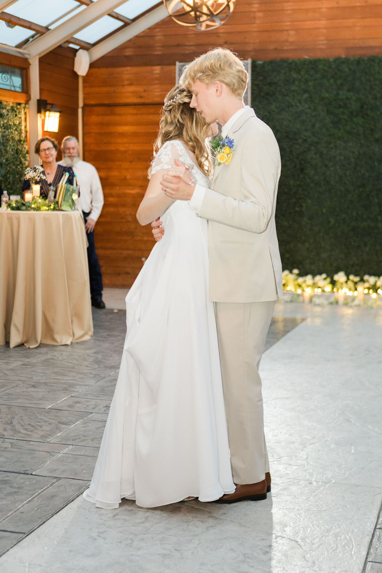 A romantic wedding dance sequence captured in a rustic indoor venue with wooden walls and skylights.