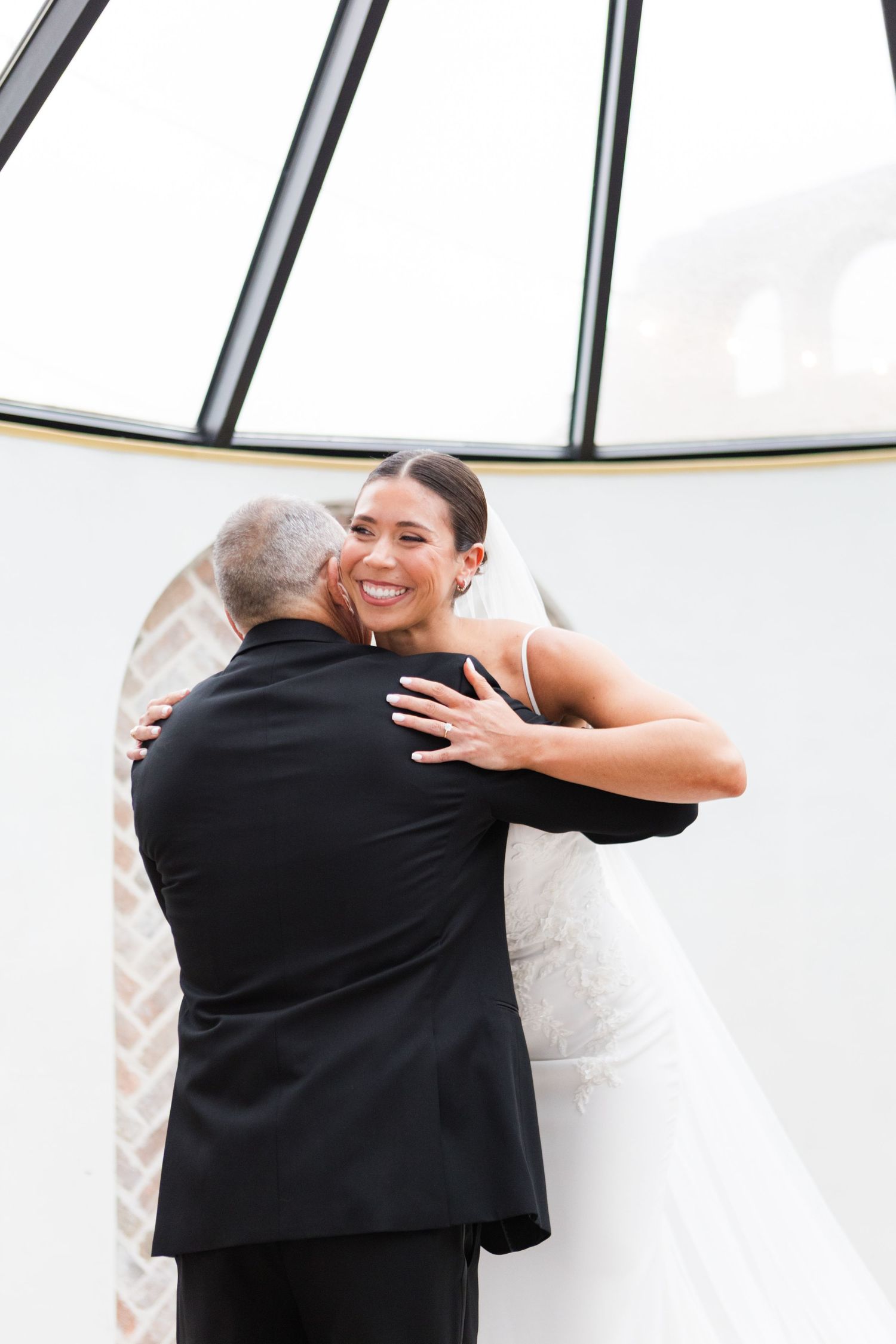 Heartwarming embrace shared during wedding day first look.