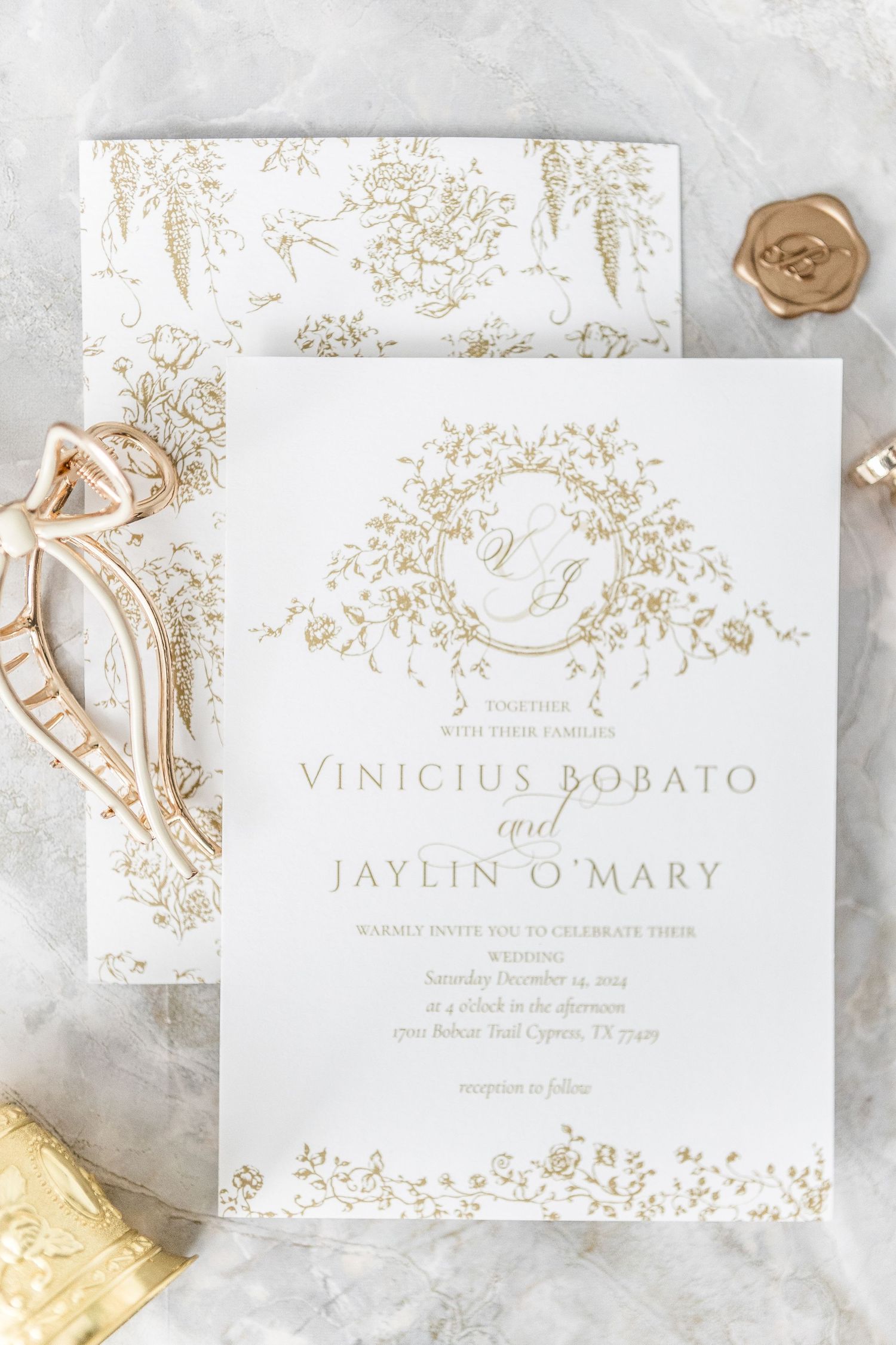 Elegant wedding invitation suite featuring gold foil floral details and classic typography.