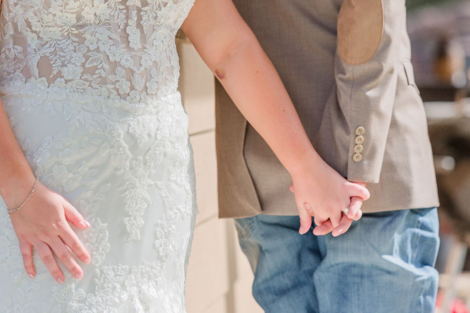 Detail shot of wedding attire showing mix of formal and country style elements.