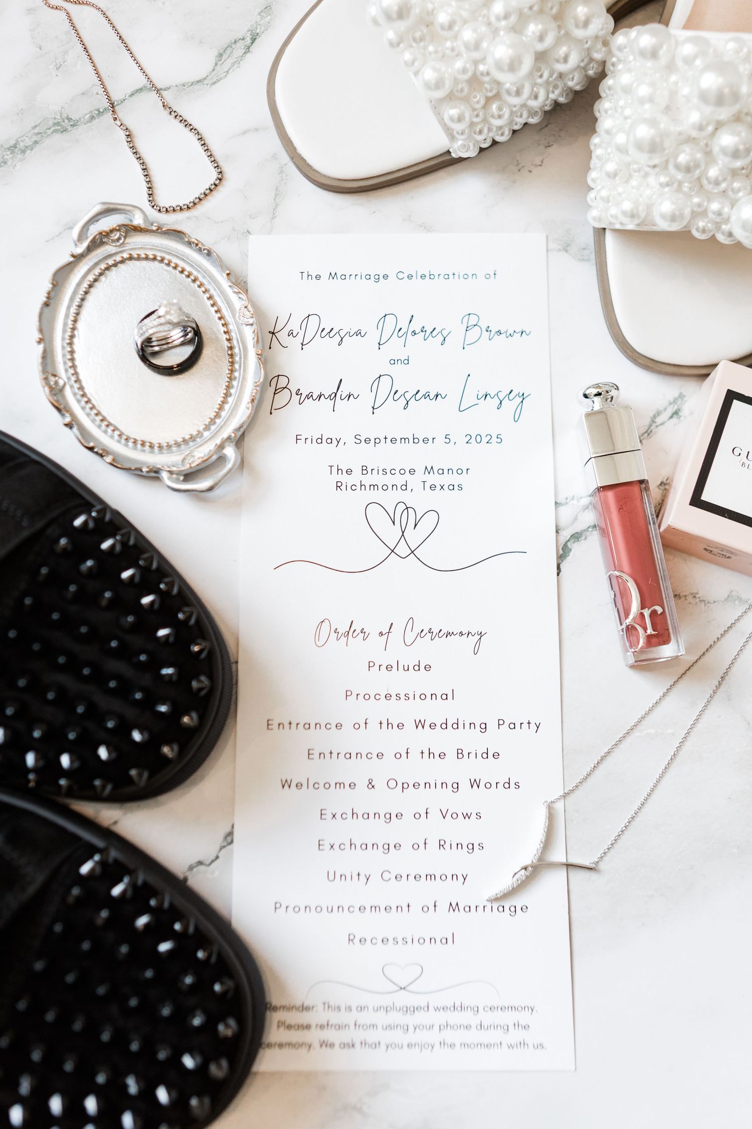 Wedding invitation suite with pearl accents and elegant calligraphy on white background.