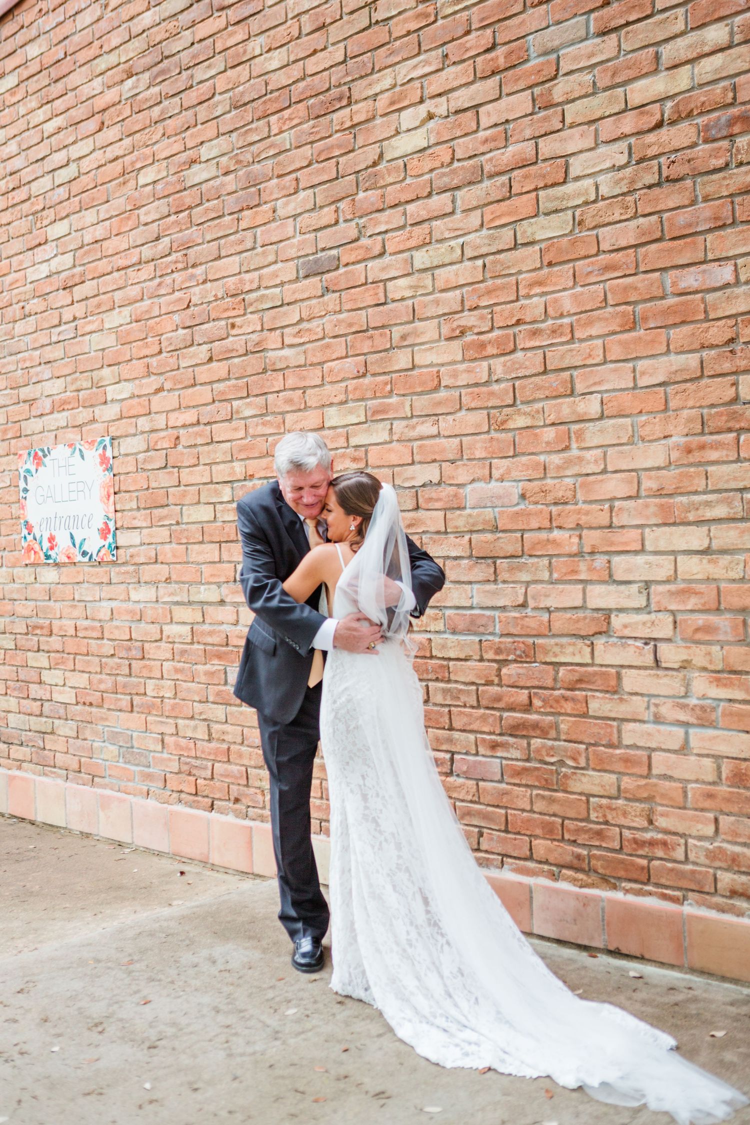Romantic posed shots against a brick wall at a wedding venue.