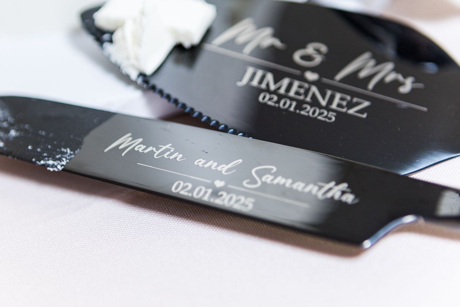 Black wedding place cards with elegant white script lettering displayed at reception.