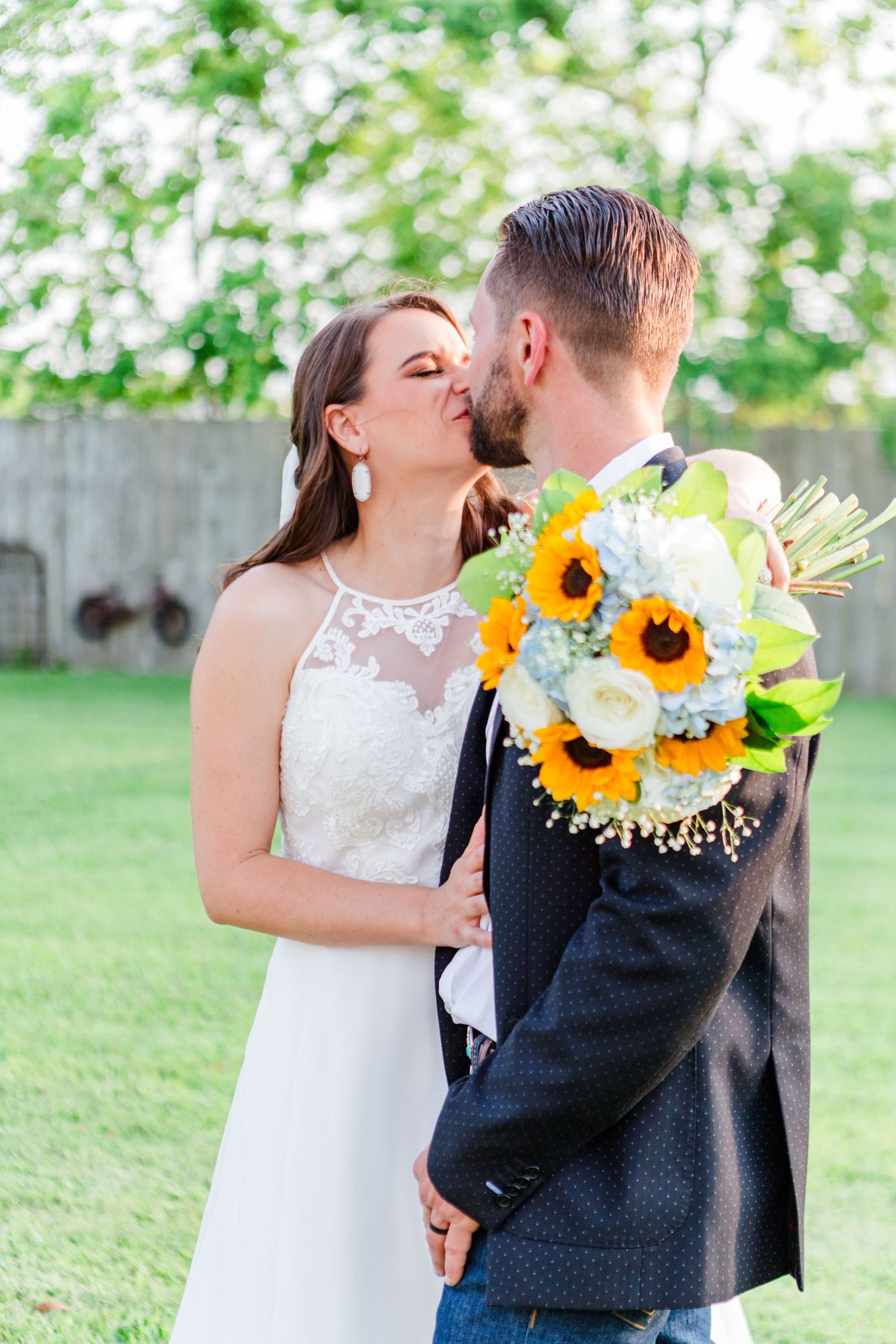 Wedding portraits featuring white and yellow florals against lush green backdrop.