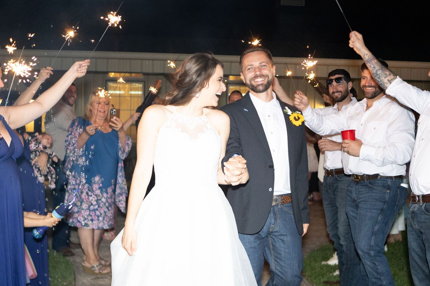 Nighttime sparkler celebration with guests creating a festive atmosphere.
