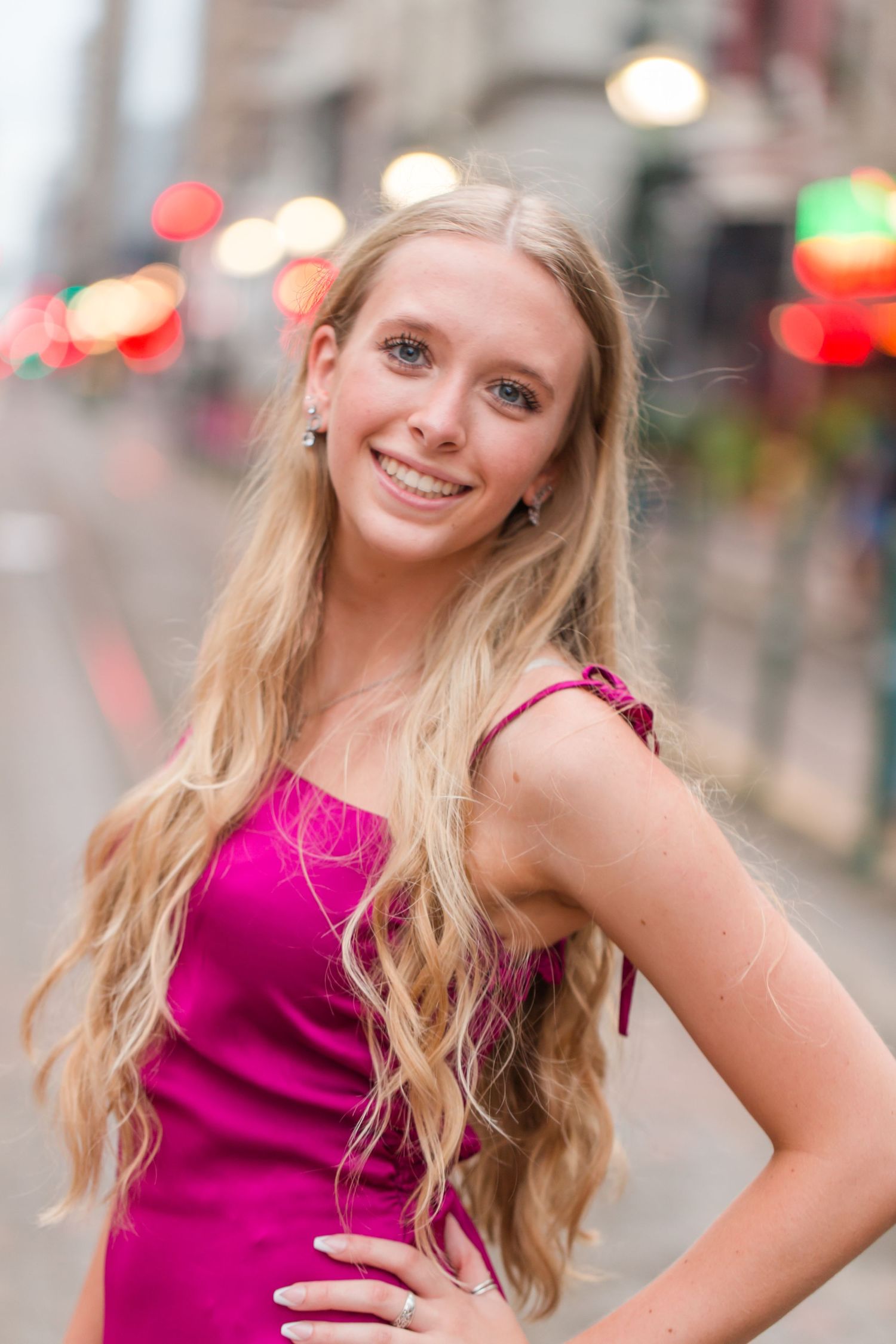 Series of portrait shots showing someone in a bright magenta top against urban background with bokeh lights.