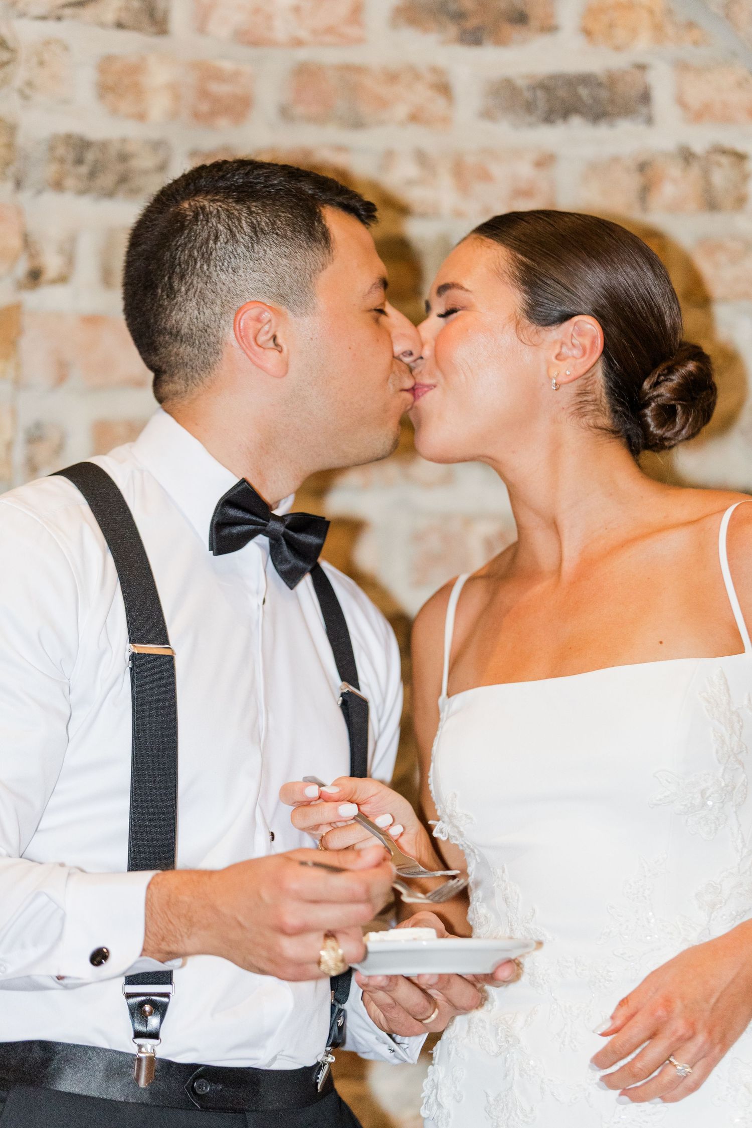 Wedding couple sharing an intimate moment during cake cutting ceremony.