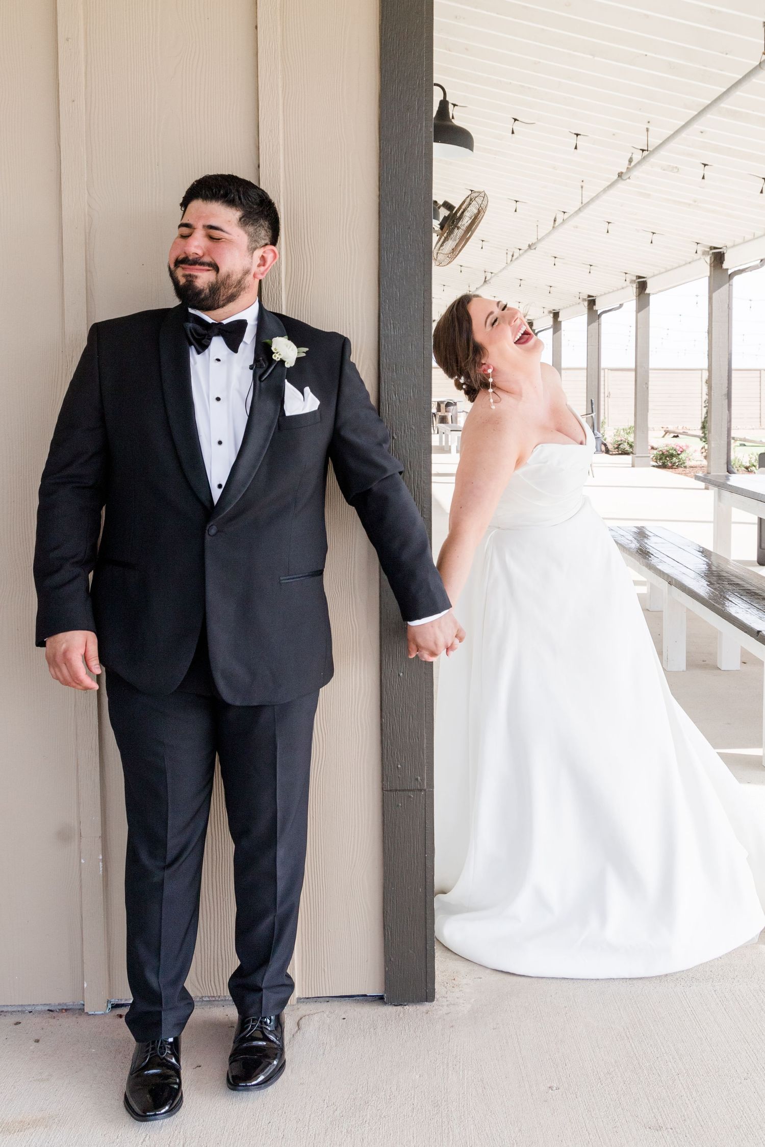 Wedding pair displays genuine laughter during their pre-ceremony photo session.