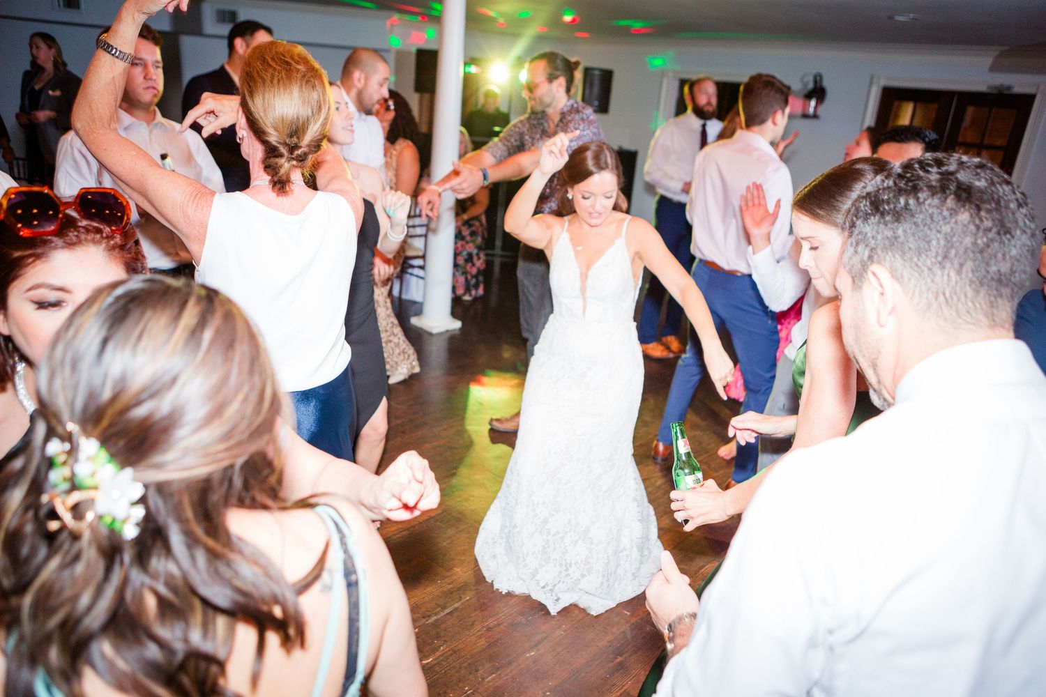 Wedding celebration with dancing guests filling a lively reception venue.