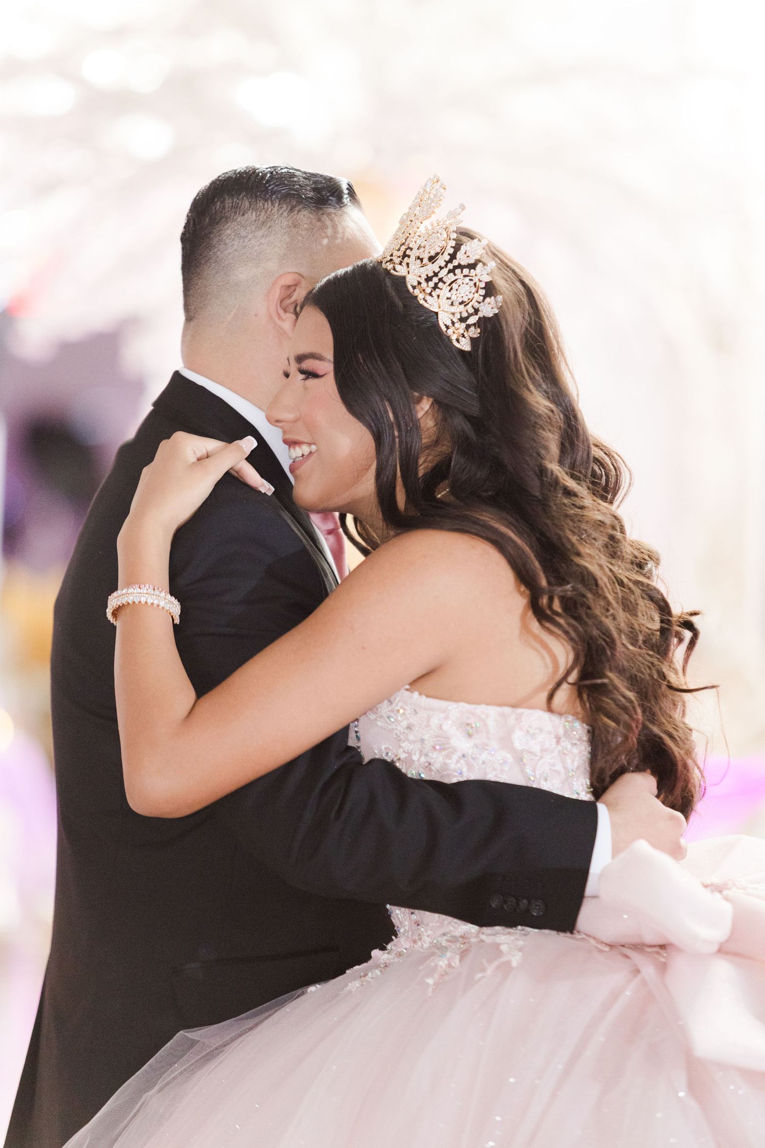 Romantic dance moment captured in a beautifully lit celebration venue.