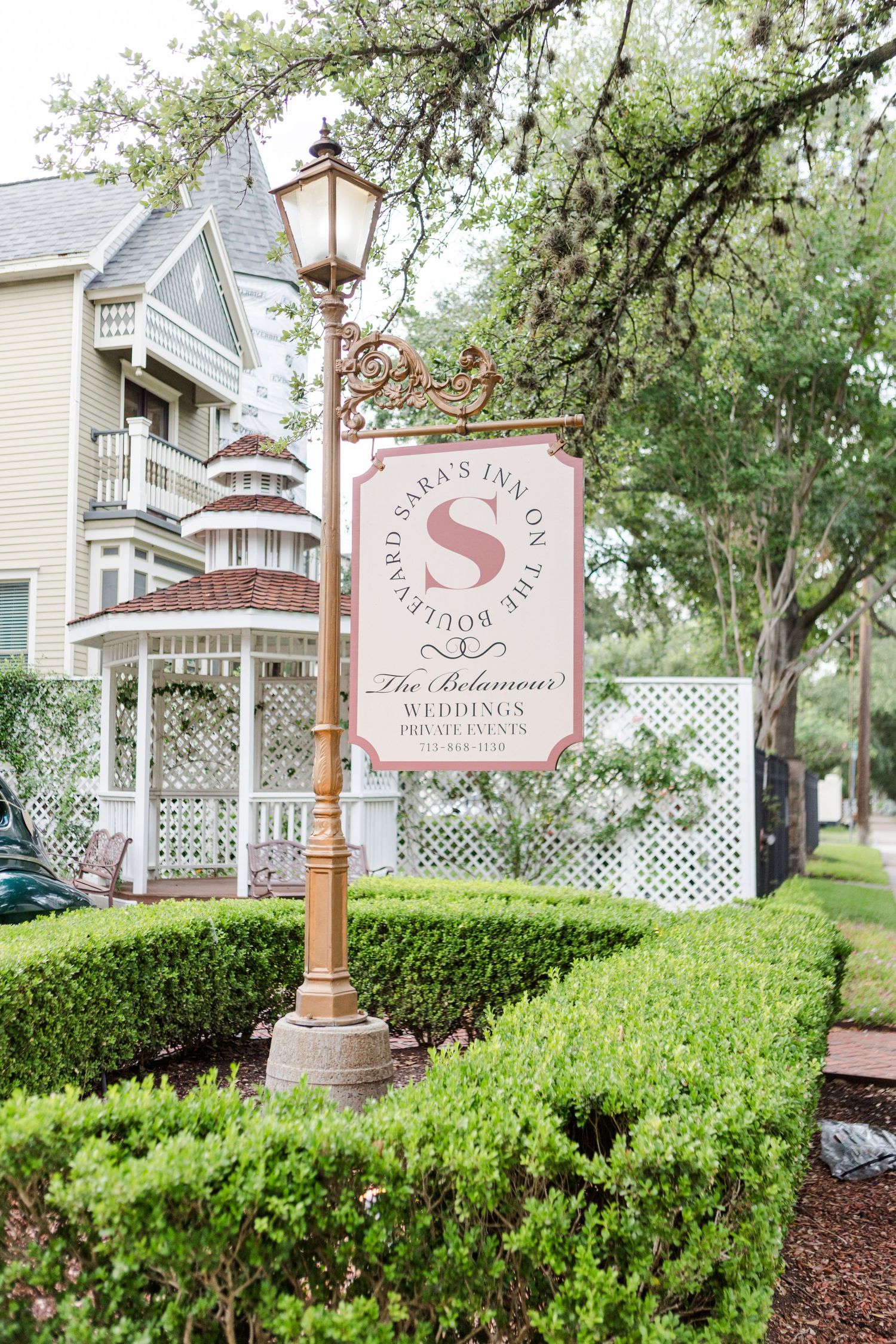 Swan House exterior entrance sign with white lattice and landscaping in Atlanta, Georgia.