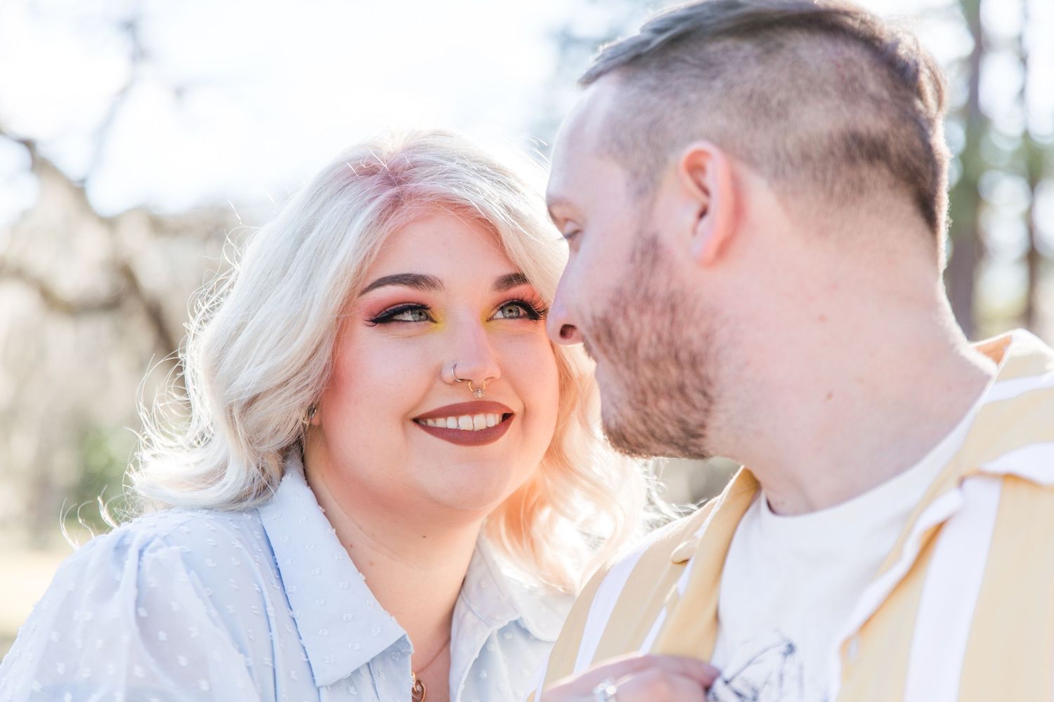 Intimate close-up moments between couple during outdoor photo session.