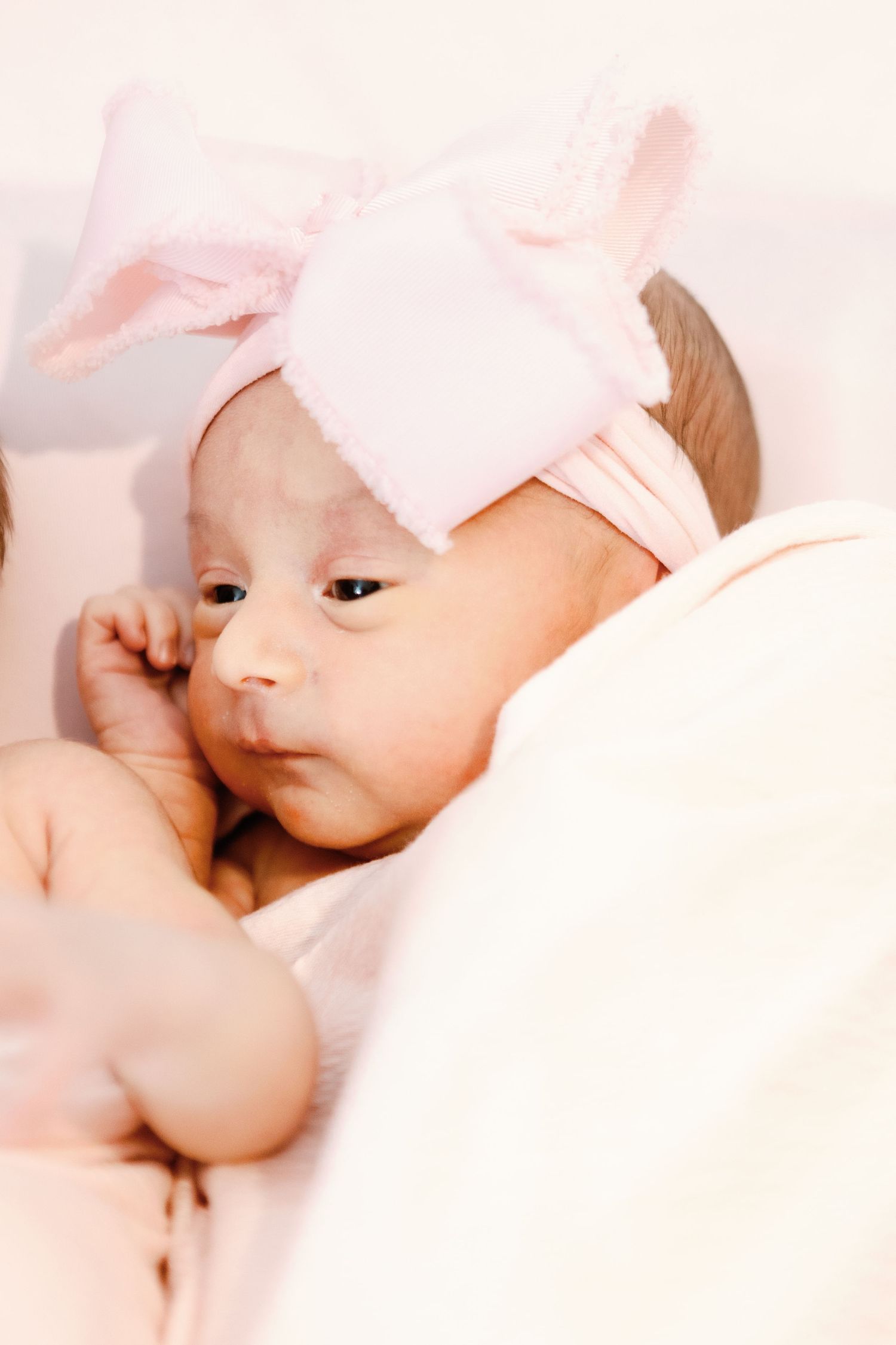 Mother and baby share tender affectionate moments while breastfeeding in soft natural lighting.